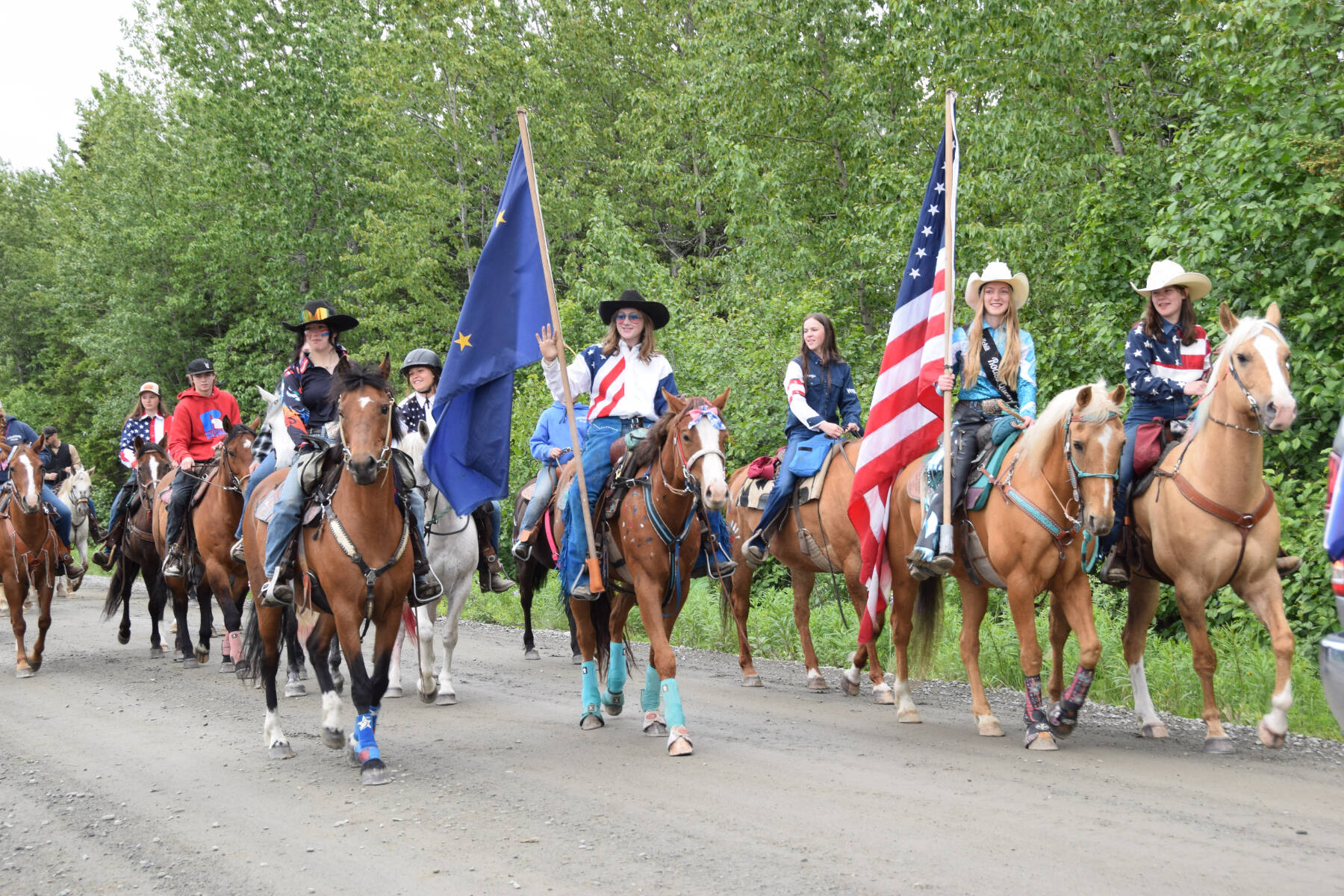 Community members ride down School Street on their horses during the Anchor Point Fourth of July parade on Tuesday, July 4, 2023 in Anchor Point, Alaska. (Delcenia Cosman/Homer News)