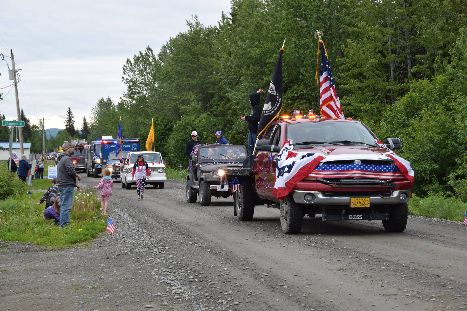 Parade participants toss candy to spectators during the Anchor Point Fourth of July parade on Tuesday, July 4, 2023 in Anchor Point, Alaska. (Delcenia Cosman/Homer News)