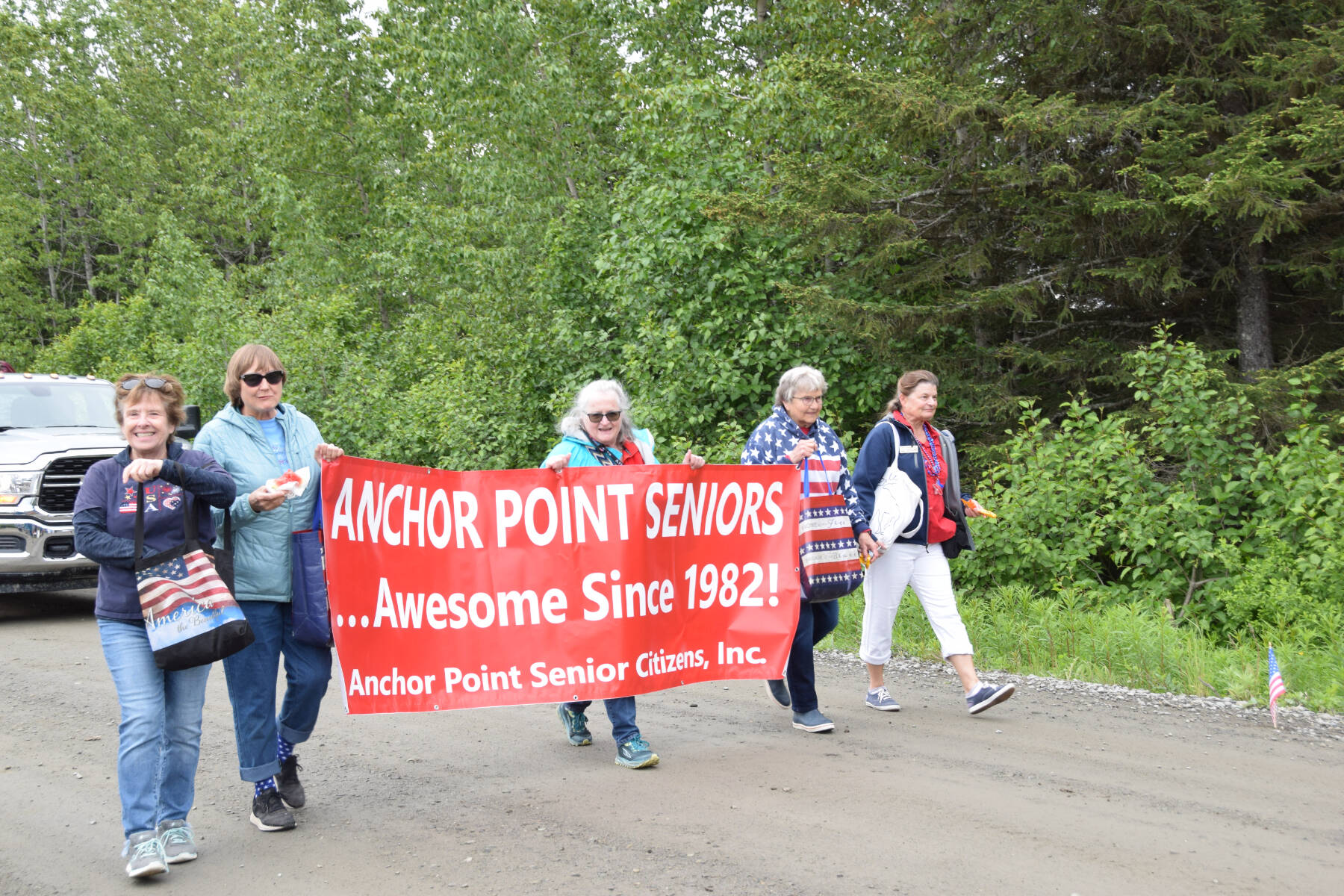 Members of the Anchor Point Senior Center walk down School Street during the Anchor Point Fourth of July parade on Tuesday, July 4, 2023 in Anchor Point, Alaska. (Delcenia Cosman/Homer News)