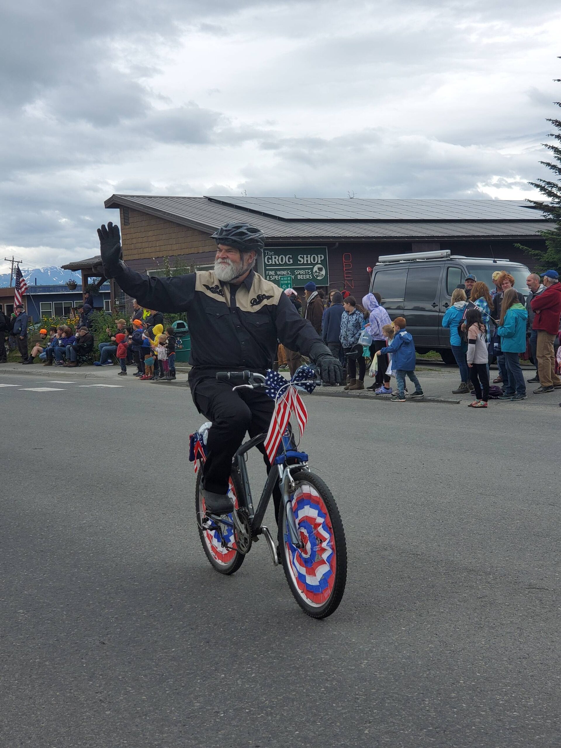 Homer mayor Ken Castner waves to the crowds gathered on Pioneer Avenue during the “Seas the Day” parade on Tuesday, July 4, 2023 in Homer, Alaska. (Delcenia Cosman/Homer News)