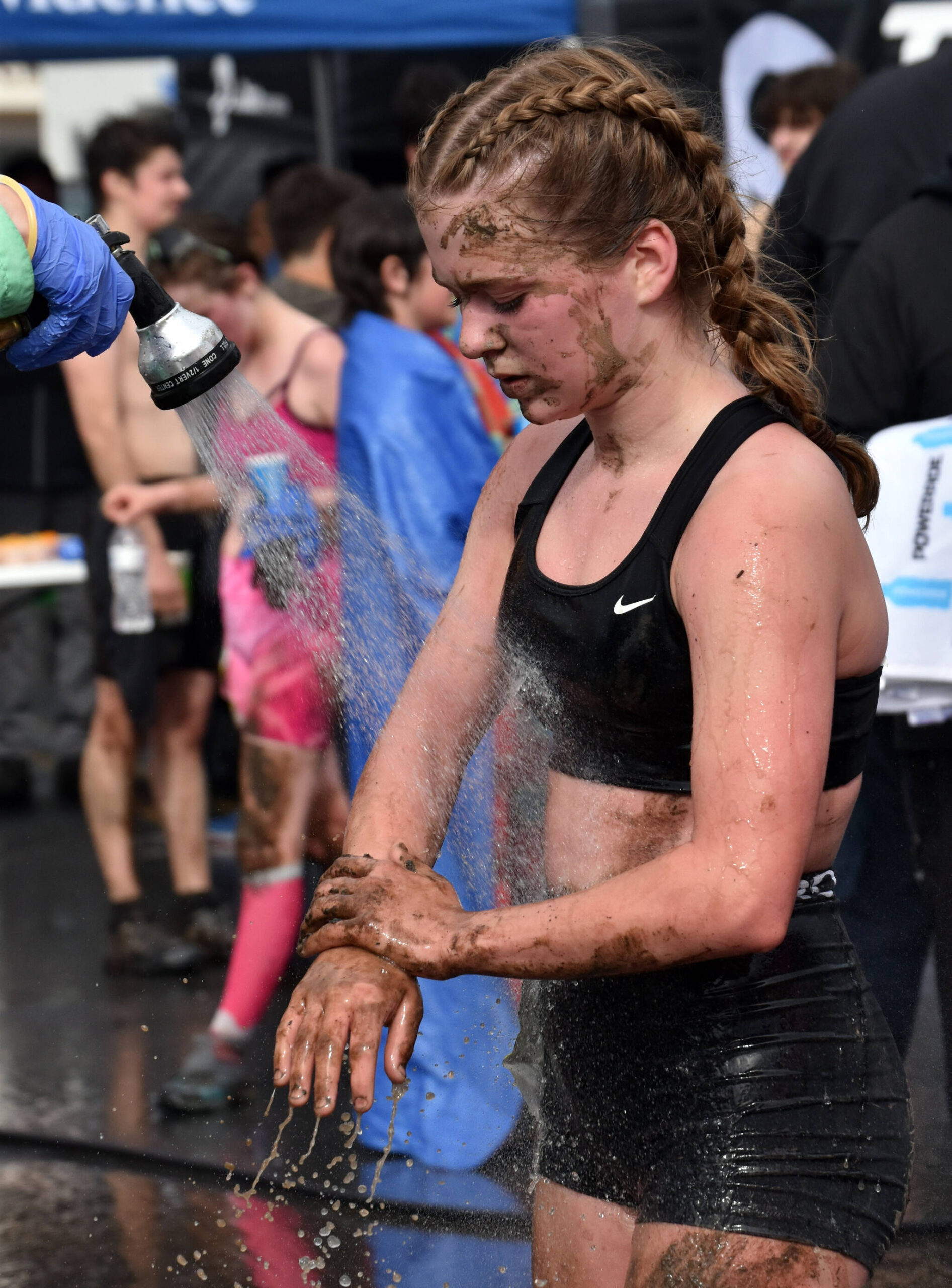 Anchorage’s Eden Rinner washes off after the girls junior Mount Marathon Race on Tuesday, July 4, 2023, in Seward, Alaska. (Photo by Jeff Helminiak/Peninsula Clarion)