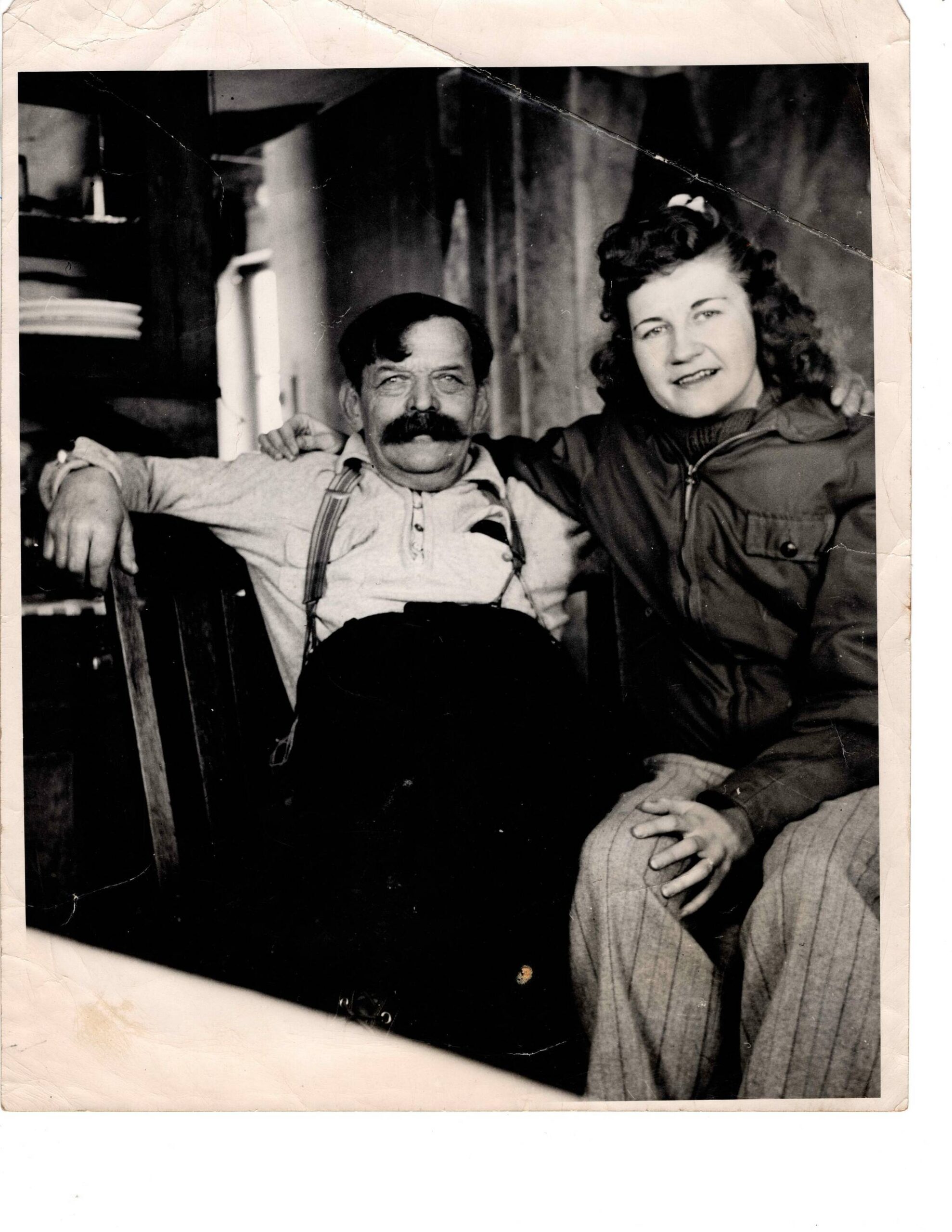 Charles “Windy” Wagner, in his later years, and an unknown woman smile for the camera in Wagner’s Kenai River cabin. (Photo courtesy of the Knackstedt Collection)