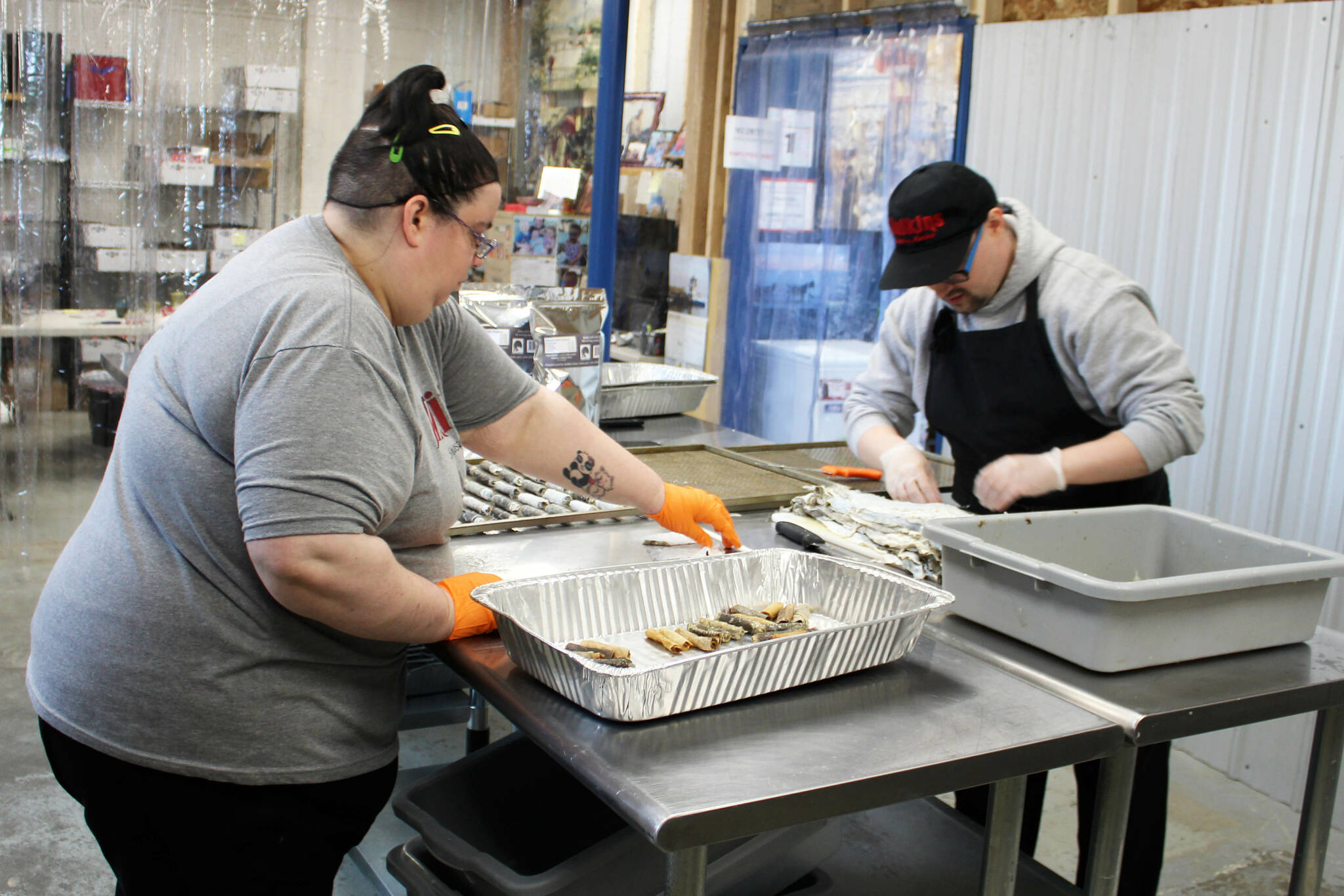 AlaSkins employees Lillie VanDevere (left) and Jeramie Davis (right) roll cod skins that will ultimately be sold as pet treats at AlaSkins on Thursday, July 6, 2023 in Soldotna, Alaska. (Ashlyn O’Hara/Peninsula Clarion)