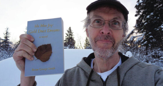 Photos provided by Brian George Smith
Author Brian George Smith poses with his book, “Ida Mae Joy: Gold Dust Dreams,” published in 2021.