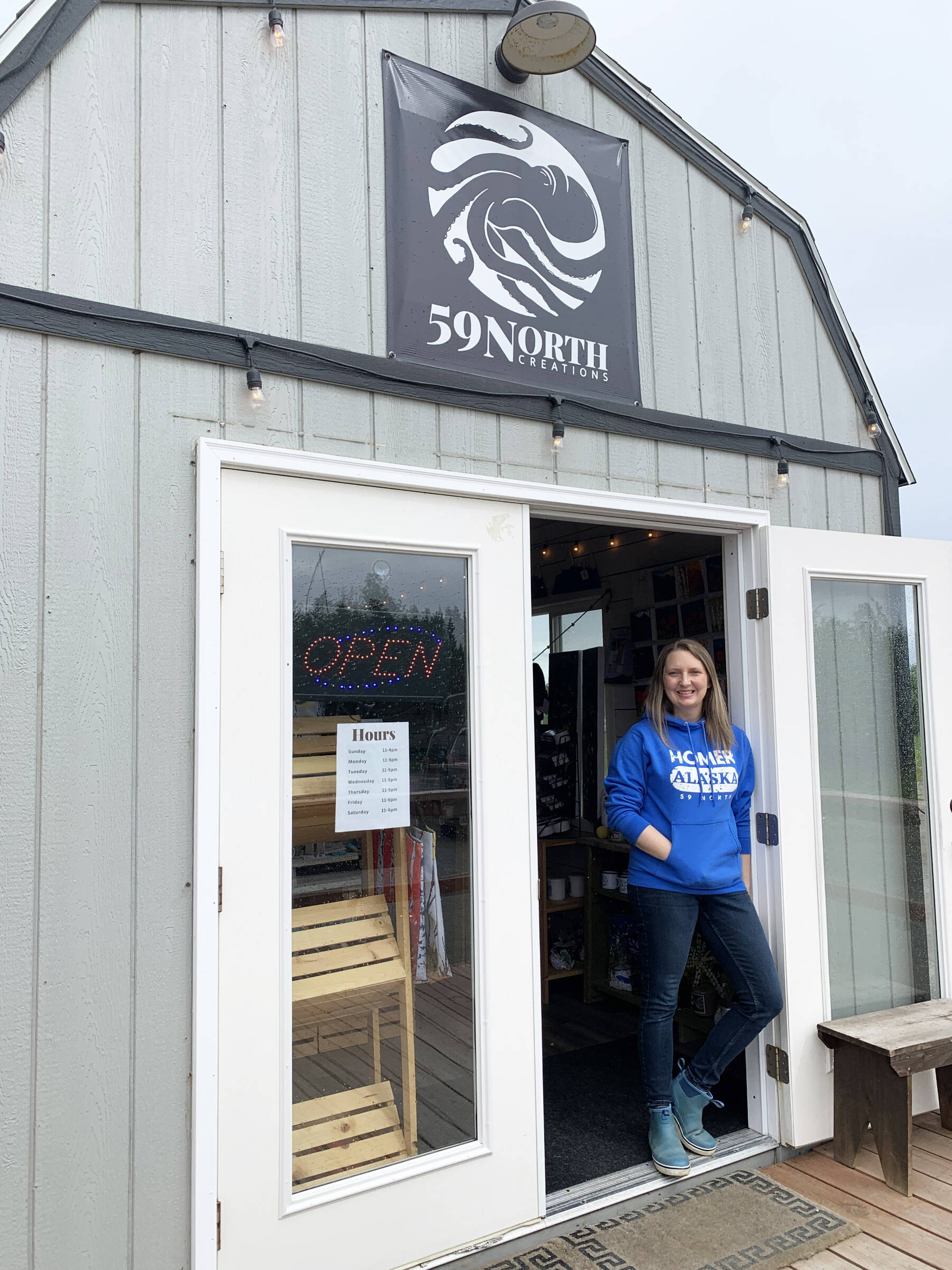 Tracy Hansen, artist and owner of 59 North Creations located at the base of the Homer Spit, is photographed in July 2023 in front of her shop in Homer, Alaska. Photo by Christina Whiting