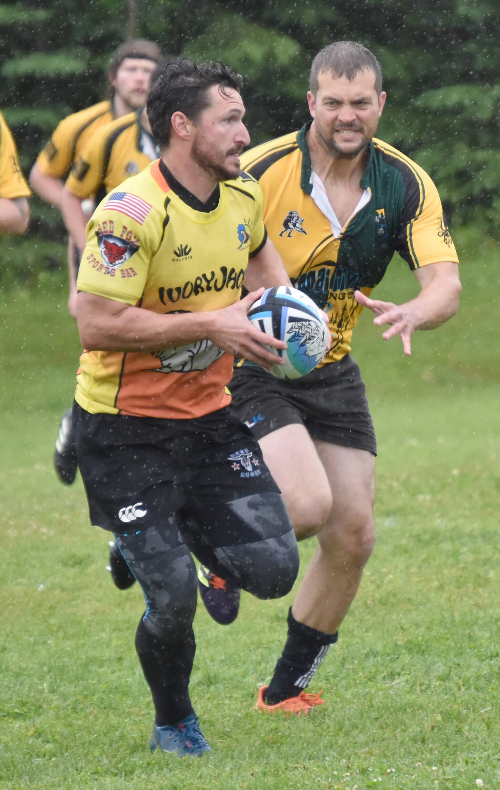 Cody Foster of the Fairbanks SunDawgs runs from Dan Engstrom of the Kenai Wolfpack on Saturday, July 15, 2023, at the Between the Tides Rugby Tourney at Millennium Square Field in Kenai, Alaska. (Photo by Jeff Helminiak/Peninsula Clarion)