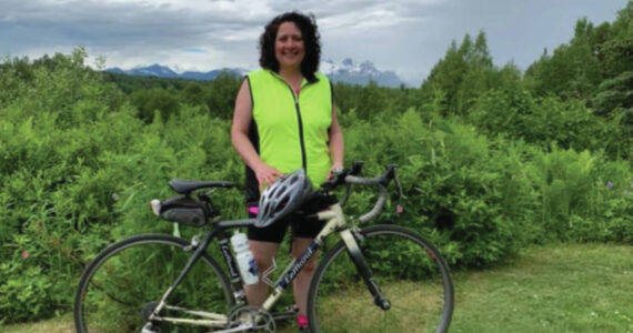 Pam Borland during a 100 mile summer training ride outside of Talkeetna, MP 50 of the Parks Highway, south view of Denali. Photo provided by Pam Borland