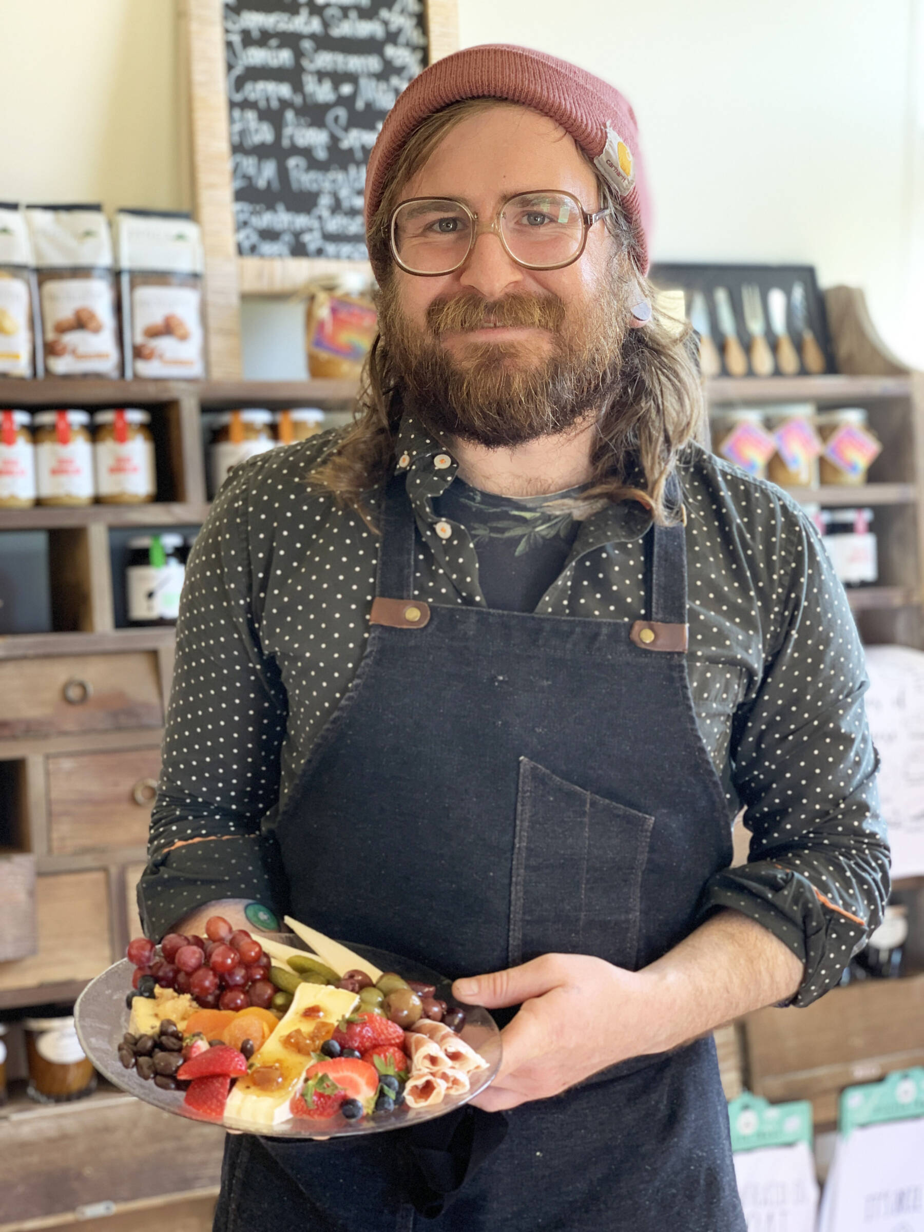 Community member Jacob Chrisman, photographed on Thursday, July 20, 2023, is the owner of Alasandro’s Market, a gourmet market specializing in imported cheeses, dry-cured meats and charcuterie platters, that opened on Heath Street in June. Photo by Christina Whiting
