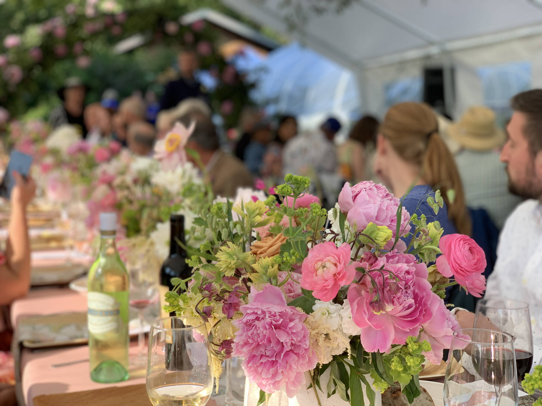 Floral bouquets line tables during an American Grown Field-to-Vase Dinner at Scenic Place Peonies on Sunday, July 23, 2023 in Homer, Alaska. Photo by Christina Whiting