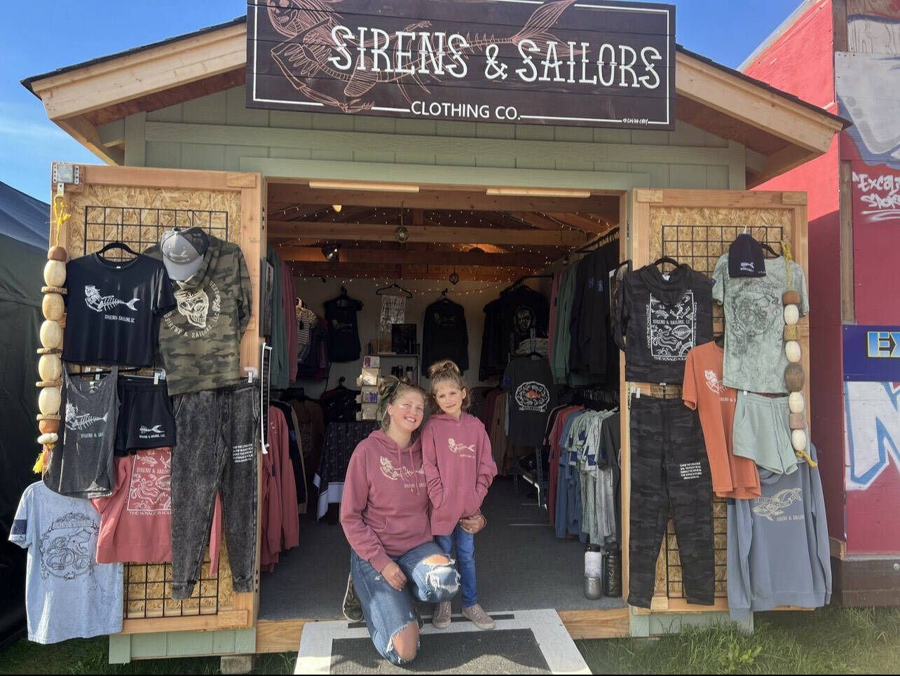 Sirens & Sailors employee Emily Jensen and her daughter Josalee wear matching Sirens & Sailors hoodies at the Sirens & Sailors booth at the 2022 Alaska State Fair in Palmer, Alaska. Photo provided by Jacqueline Burke