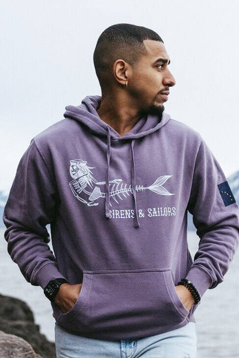 A Sirens & Sailors hoodie, photographed in the summer of 2023, showcases a sample of the Homer business’s artwork. Photo by Kristian Irey
