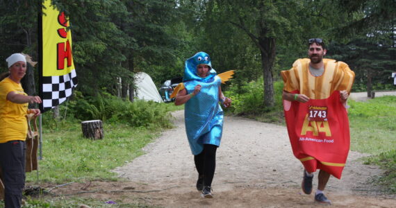 “Fish and chips” costumed runners cross the finish line in the inaugural Great Salmon Run 5K race on Saturday, Aug. 5, 2023 during Salmonfest at the Kenai Peninsula Fairgrounds in Ninilchik, Alaska.