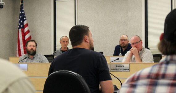 Outlaw Body and Paint’s Wesley Jackson, center, testifies before the Kenai Peninsula Borough Assembly about the affects of calcium chloride brine on vehicles he treats during a meeting on Tuesday, Aug. 2, 2023, in Soldotna, Alaska. (Ashlyn O’Hara/Peninsula Clarion)