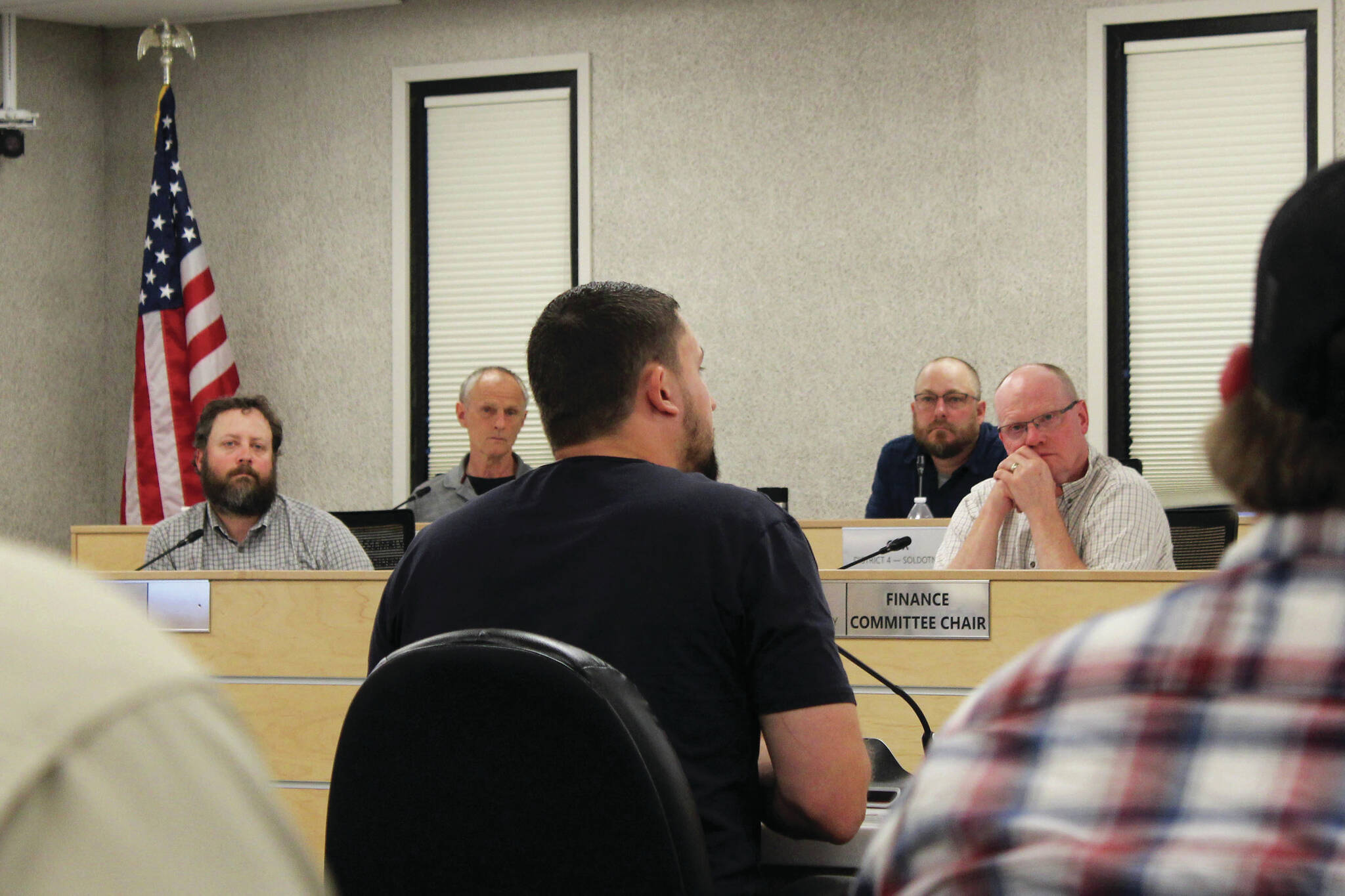 Outlaw Body and Paint’s Wesley Jackson (center) testifies before the Kenai Peninsula Borough Assembly about the affects of calcium chloride brine on vehicles he treats during a meeting on Tuesday in Soldotna. (Ashlyn O’Hara/Peninsula Clarion)