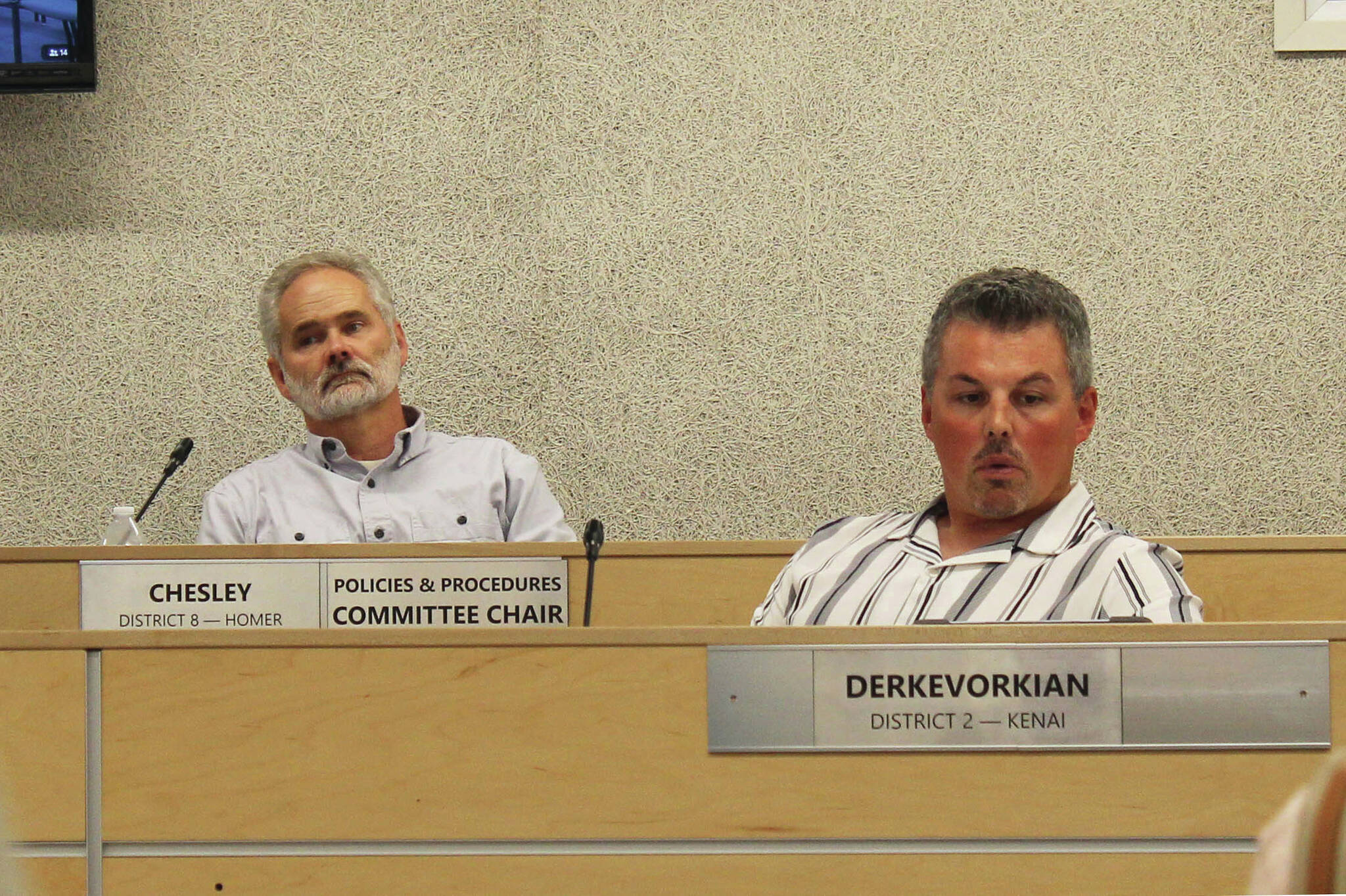 Assembly members Lane Chesley (left) and Richard Derkevorkian (right) participate in a borough assembly meeting on Tuesday in Soldotna . (Ashlyn O’Haara/Peninsula Clarion)