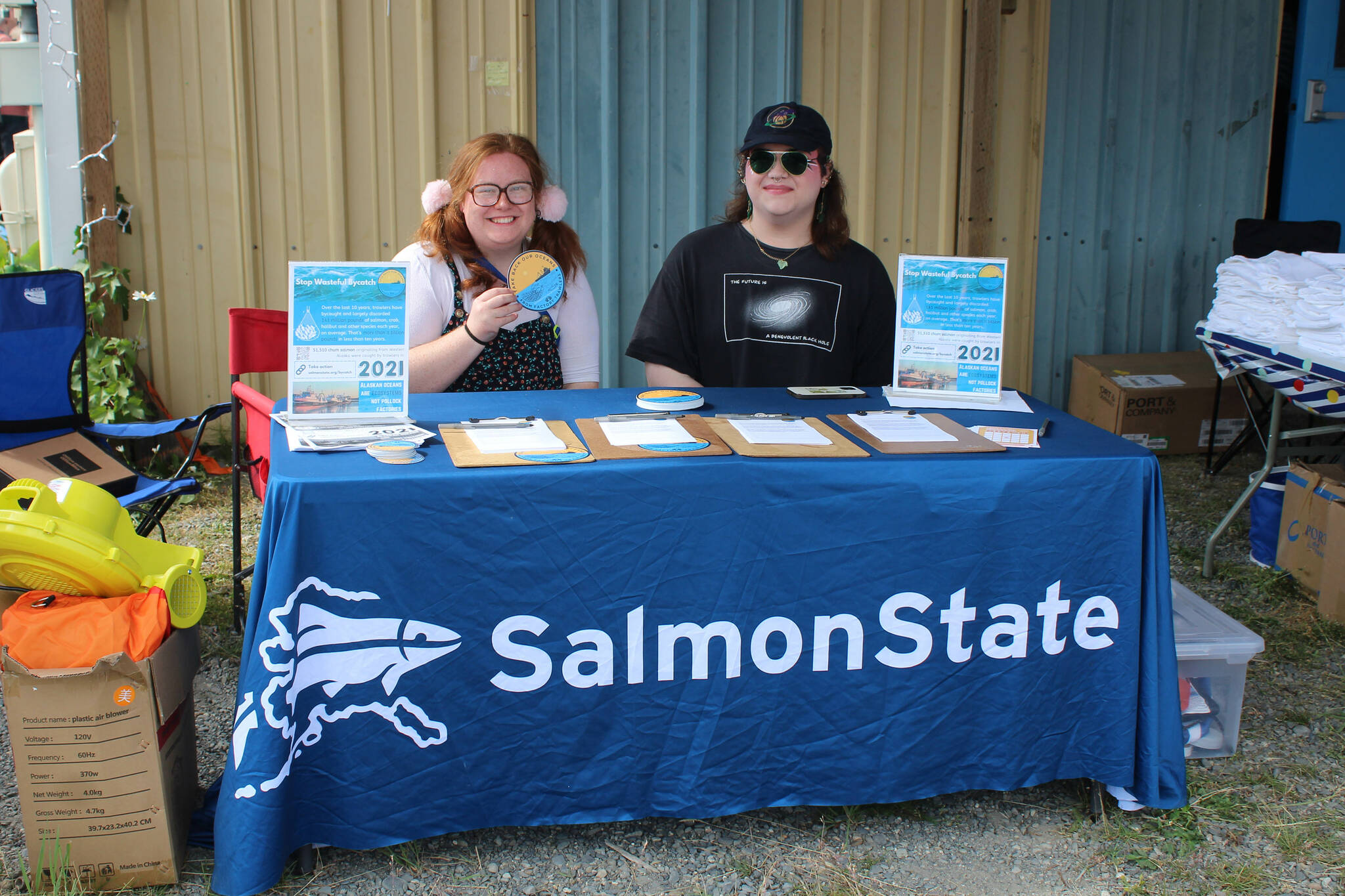 Teresa Wrobel (left) and Allison Dill (right) raise awareness about trawler bycatch at a booth at Salmonfest on Friday, Aug. 4, 2023 in Ninilchik, Alaska. (Ashlyn O’Hara/Peninsula Clarion)