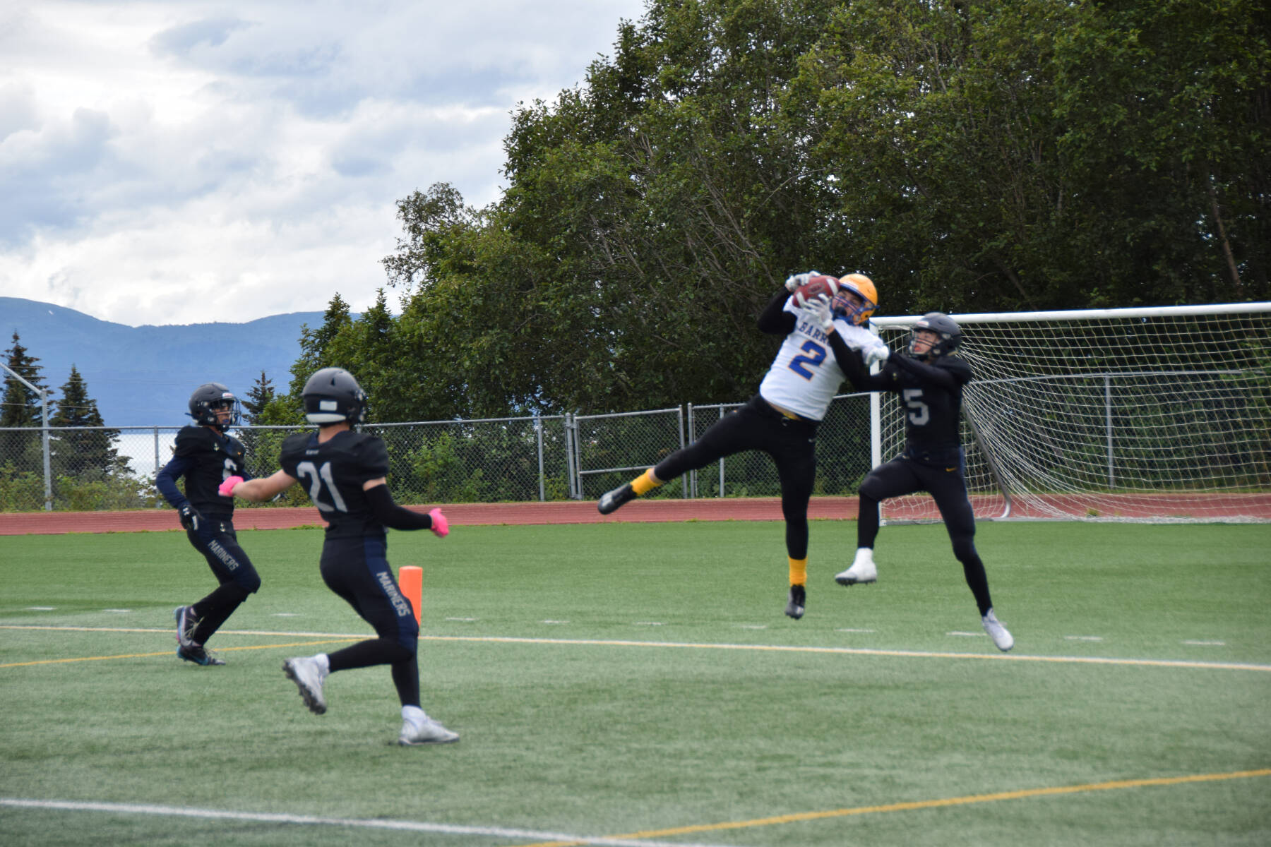 Barrow’s Ethan Goodwin catches a pass from Dwight Unutoa, taking the Whalers’ first touchdown of the game on Saturday, Aug. 12, 2023 in Homer, Alaska (Delcenia Cosman/Homer News)