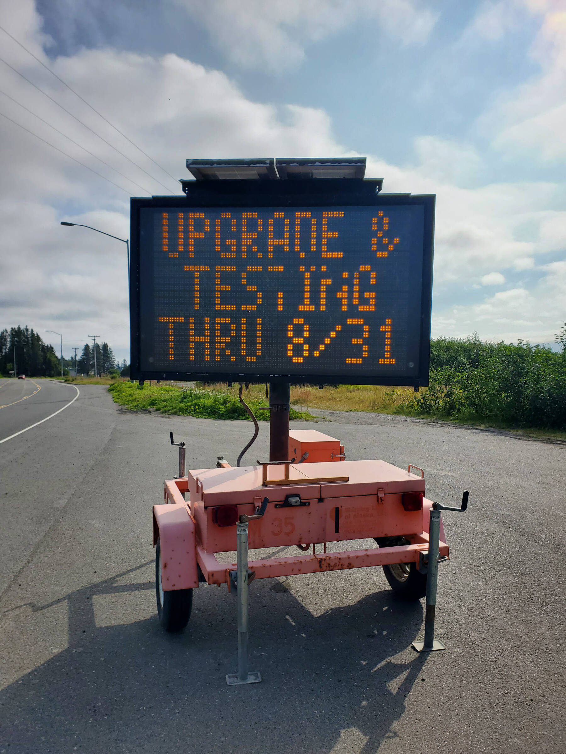 A traffic message board on the Sterling Highway on Friday, Aug. 18, 2023 alerts community members that tsunami siren upgrades and testing will continue through Aug. 31 in Homer, Alaska. (Delcenia Cosman/Homer News)