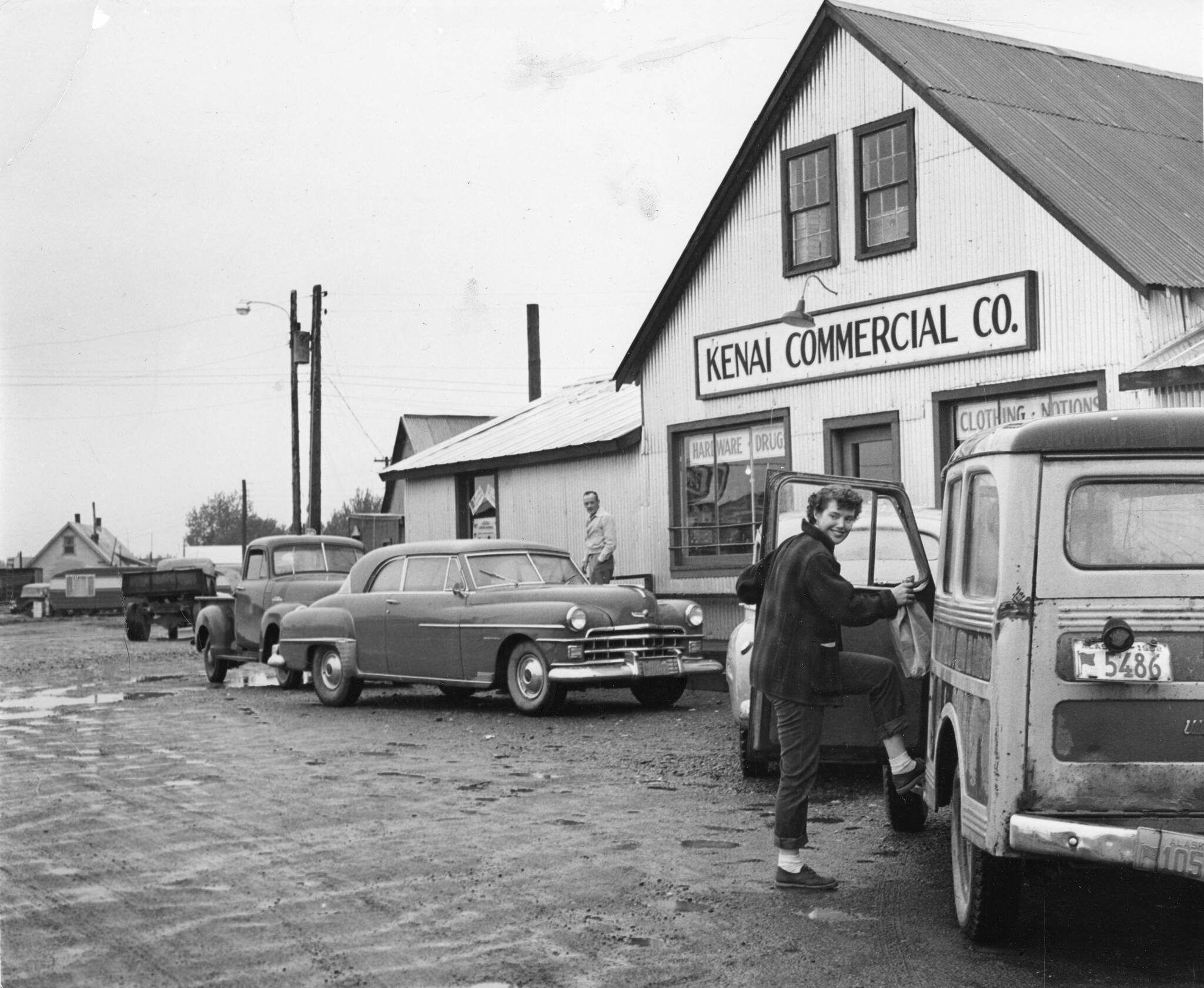 1954 photo by Bob and Ira Spring for Better Homes & Garden magazine
After doing business in the Kenai Commercial Company store, Rusty Lancashire climbs into family station wagon, with its sagging back bumper, to head for home.