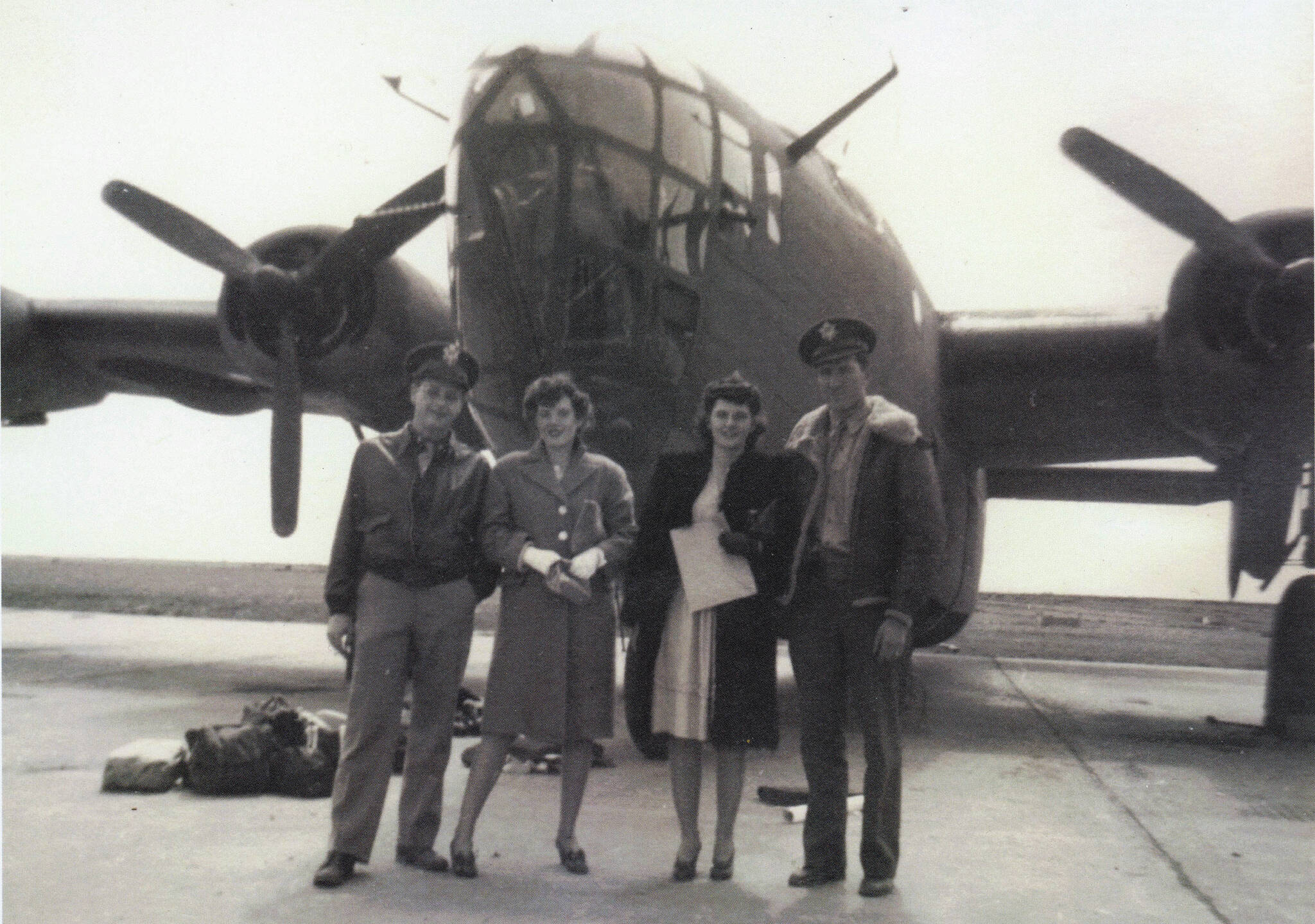 Photo courtesy of the Lancashire Family Collection
Larry and Rusty Lancashire (at left) pose in front of a B-24 bomber in the early 1940s with another unidentified couple. Larry was a B-24 co-pilot during World War II.