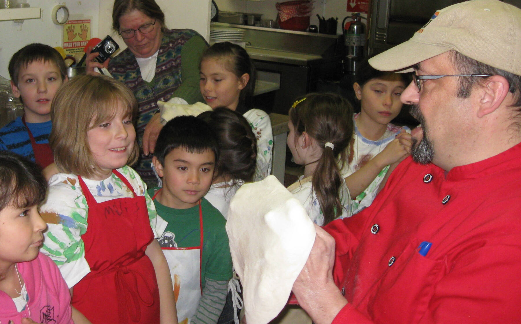 Rosco’s owner, Ross Cameron (right) demonstrates making pizza dough during a kids’ cooking class in 2012 in Ninilchik, Alaska. Photo provided by Ross Cameron
