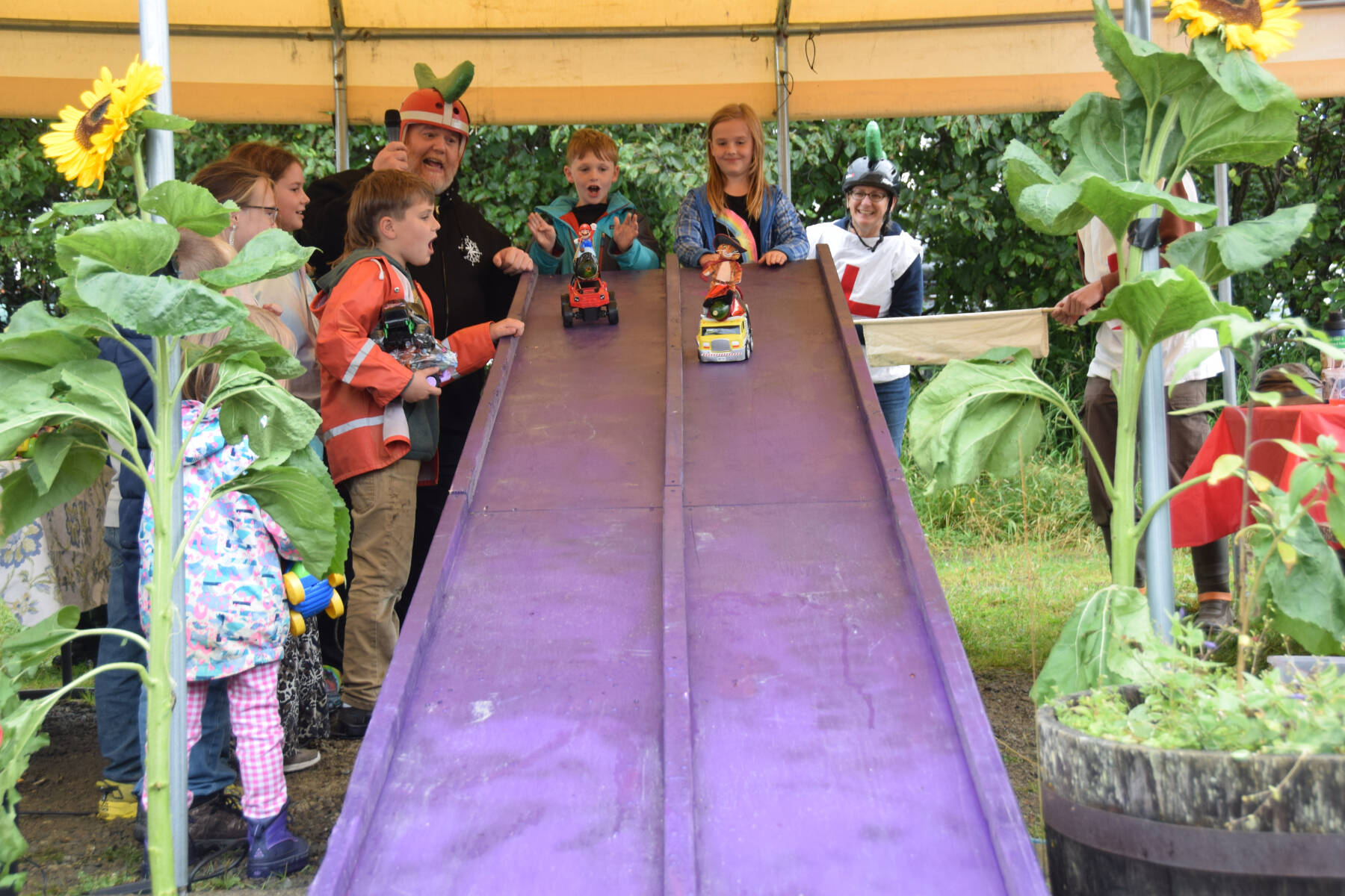 Kids race their crafted zucchini cars at the Homer Farmers Market Zucchini Festival on Saturday, Aug. 26, 2023 in Homer, Alaska. (Delcenia Cosman/Homer News)