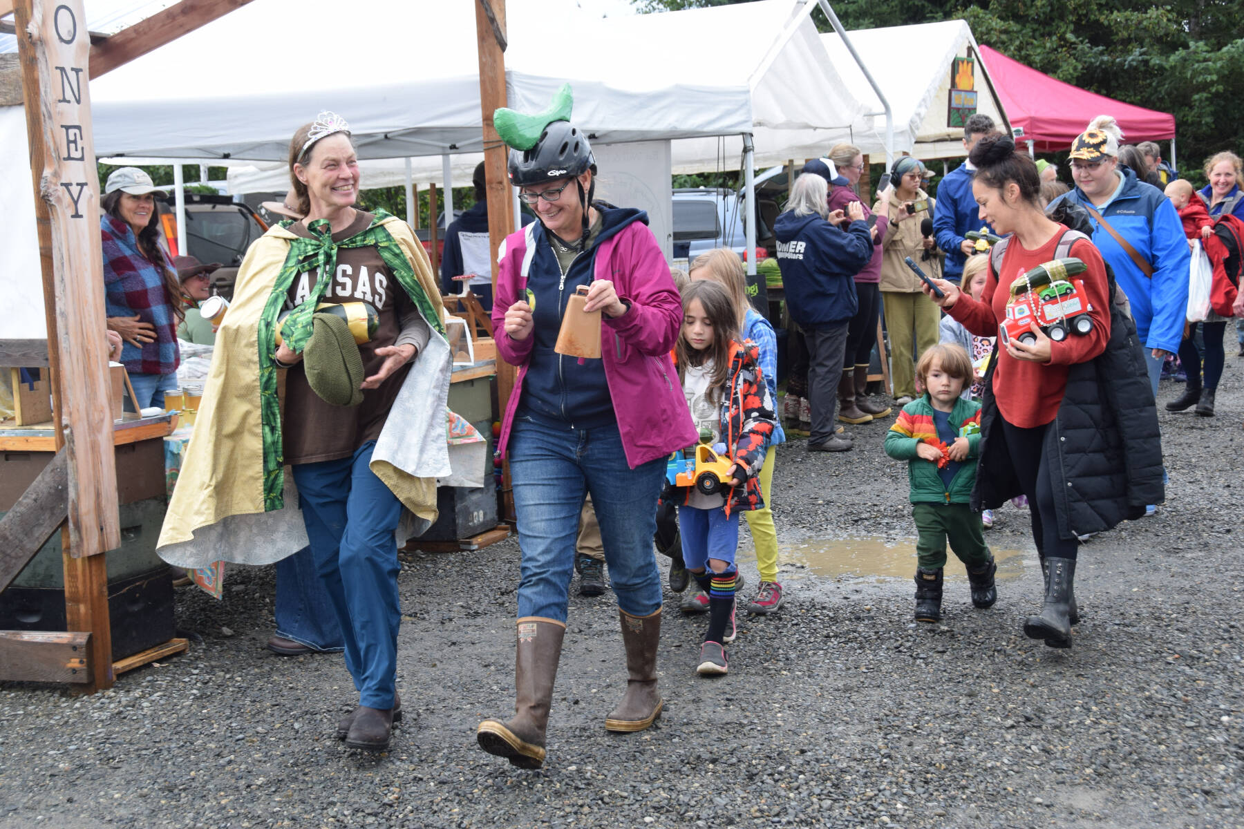 Newly-crowned Zucchini Queenie Jen Castellani, front left, leads the parade back to the race tent at the Homer Farmers Market Zucchini Festival on Saturday, Aug. 26, 2023 in Homer, Alaska. (Delcenia Cosman/Homer News)