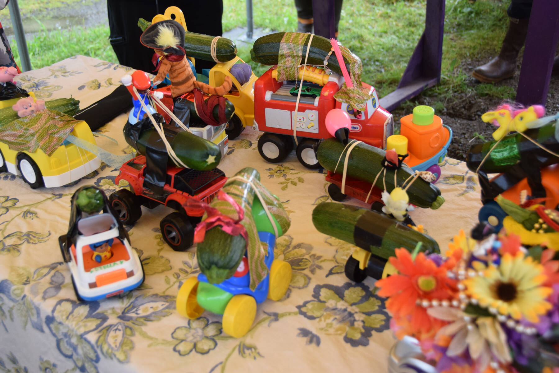 Zucchini cars crafted by participating kids are ready to race at the Homer Farmers Market Zucchini Festival on Saturday, Aug. 26, 2023 in Homer, Alaska. (Delcenia Cosman/Homer News)