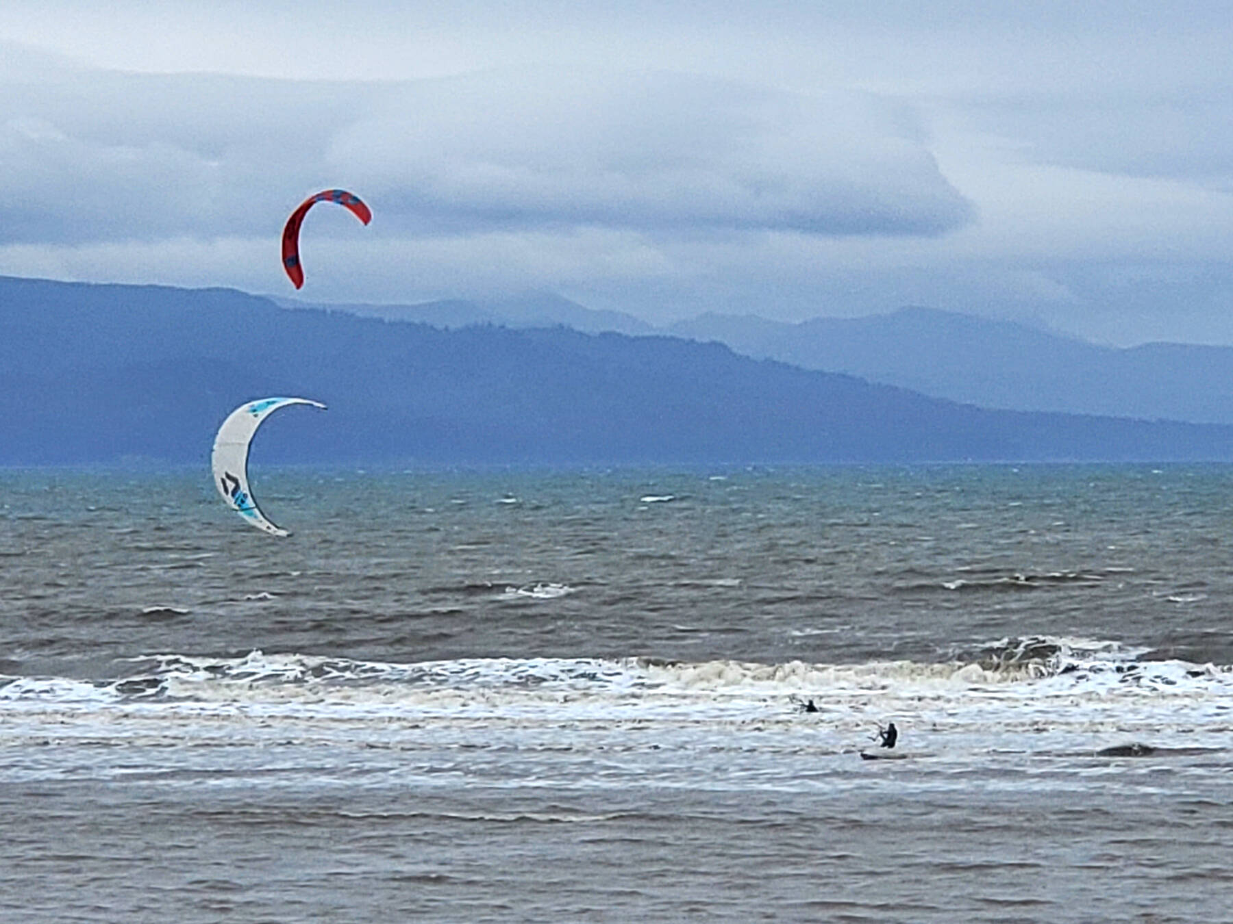 Adventurous kitesurfers brave the cold waters of Kachemak Bay next to the Spit on Saturday, Sept. 2, 2023 in Homer, Alaska. (Delcenia Cosman/Homer News)