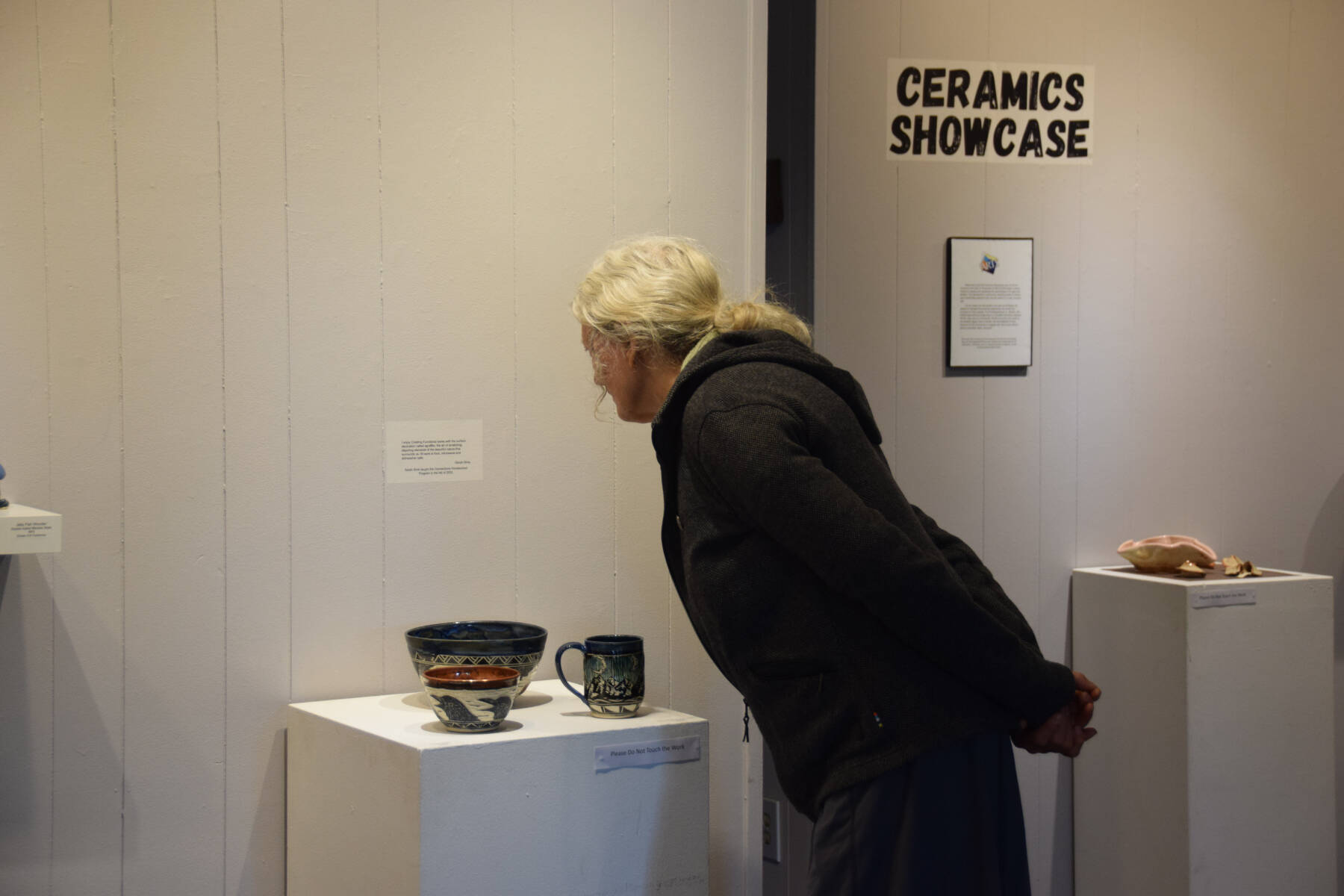 A community member peruses the ceramics on display at Homer Council on the Arts’ First Friday showcase on Sept. 1 in Homer, Alaska. (Delcenia Cosman/Homer News)