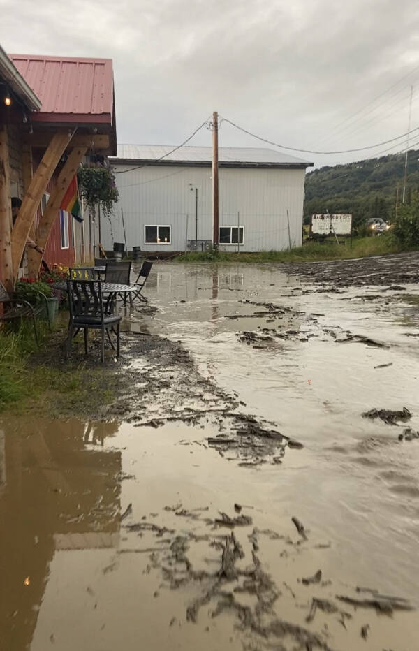 Stormwater and debris washes down from East End Road to The Bagel Shop parking lot during the heavy rains and subsequent flooding on Saturday, Aug. 26, 2023 in Homer, Alaska. Photo provided by Mikela Aramburu
