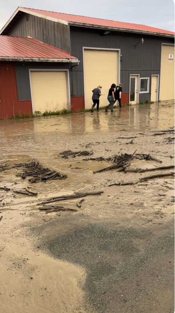 The Bagel Shop employees and owner Mikela Aramburu wade through the mud to get to the shop on Saturday, Aug. 26, 2023 in Homer, Alaska. Photo provided by Mikela Aramburu