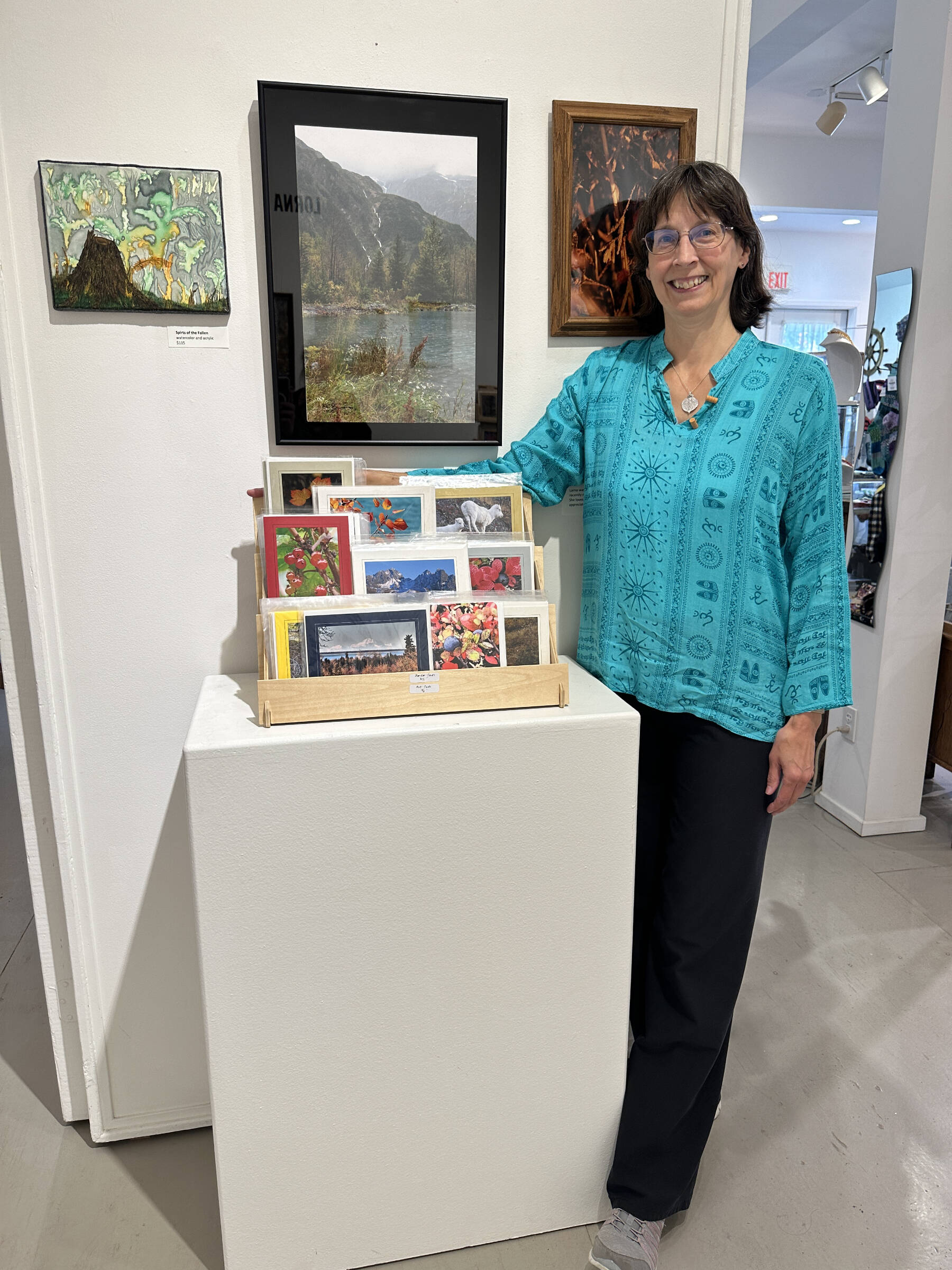 Lorna Branzuela stands with some of her artwork at Fireweed Gallery on Saturday, Sept. 2, 2023 in Homer, Alaska. Branzuela's exhibit will be on display through September. Photo by Christina Whiting