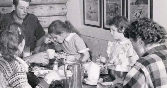 The Lancashire family shares a meal in their original homestead cabin. (1954 photo by Bob and Ira Spring for Better Homes & Garden magazine)