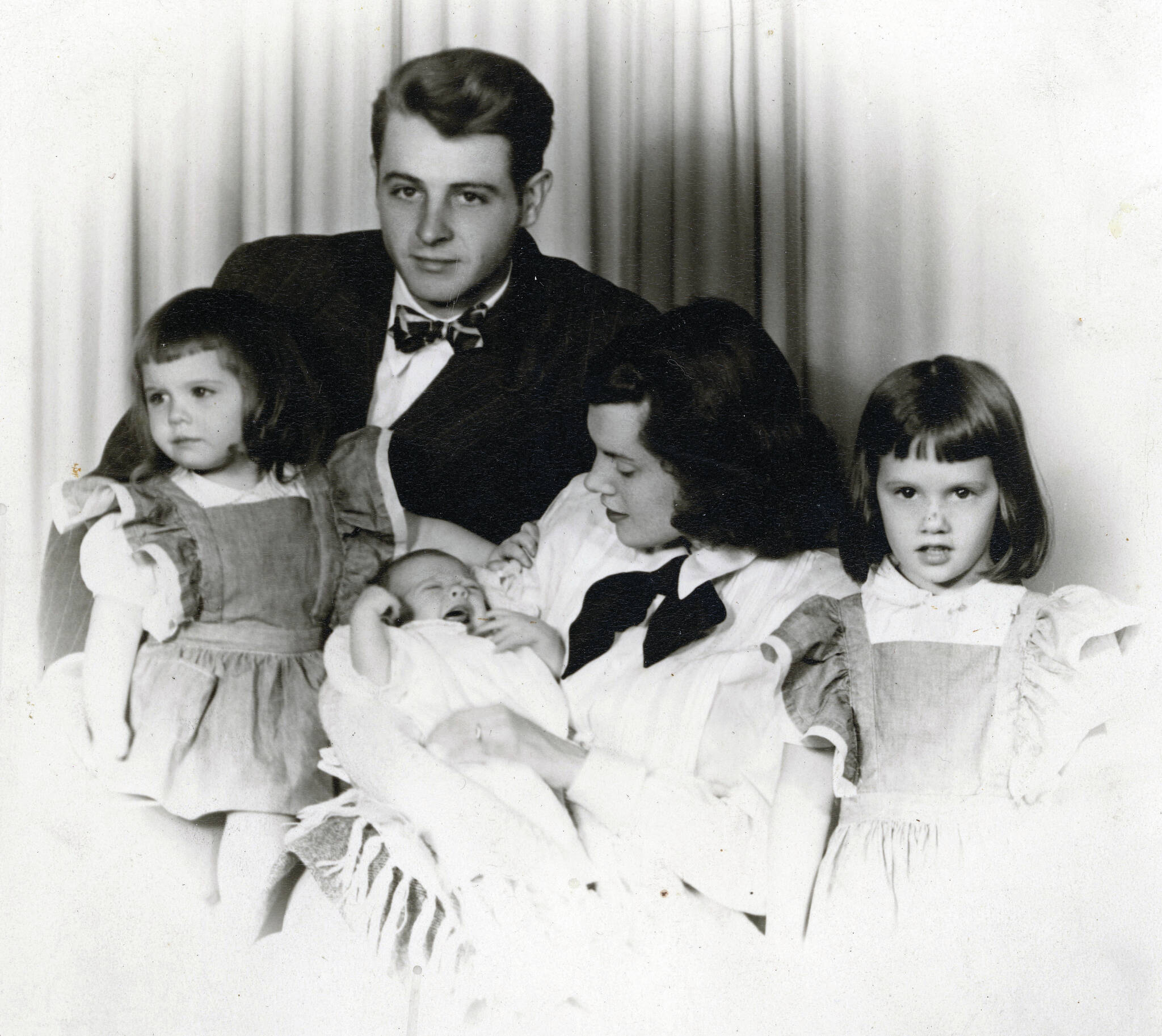 Larry and Rusty Lancashire pose for a formal portrait late fall 1947 with their young family prior to moving to Alaska. Middle daughter Lori is at left, and eldest daughter Martha is at right. In Rusty’s arms is newborn Abby. (Photo courtesy of the Lancashire Family Collection)