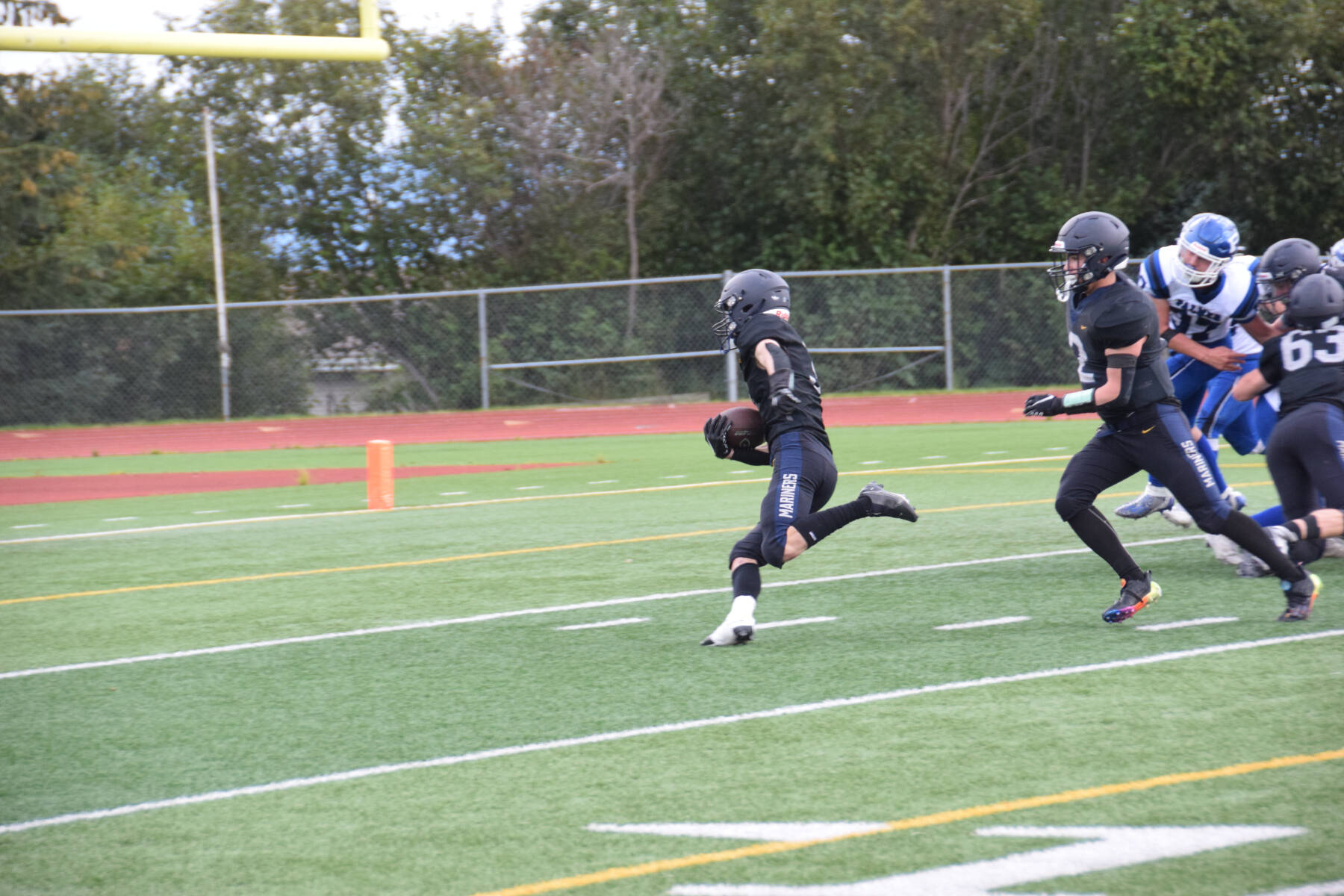 Jonah Martin (center) runs for a touchdown at the homecoming game versus Palmer on Friday, Sept. 8, 2023 in Homer, Alaska. (Delcenia Cosman/Homer News)