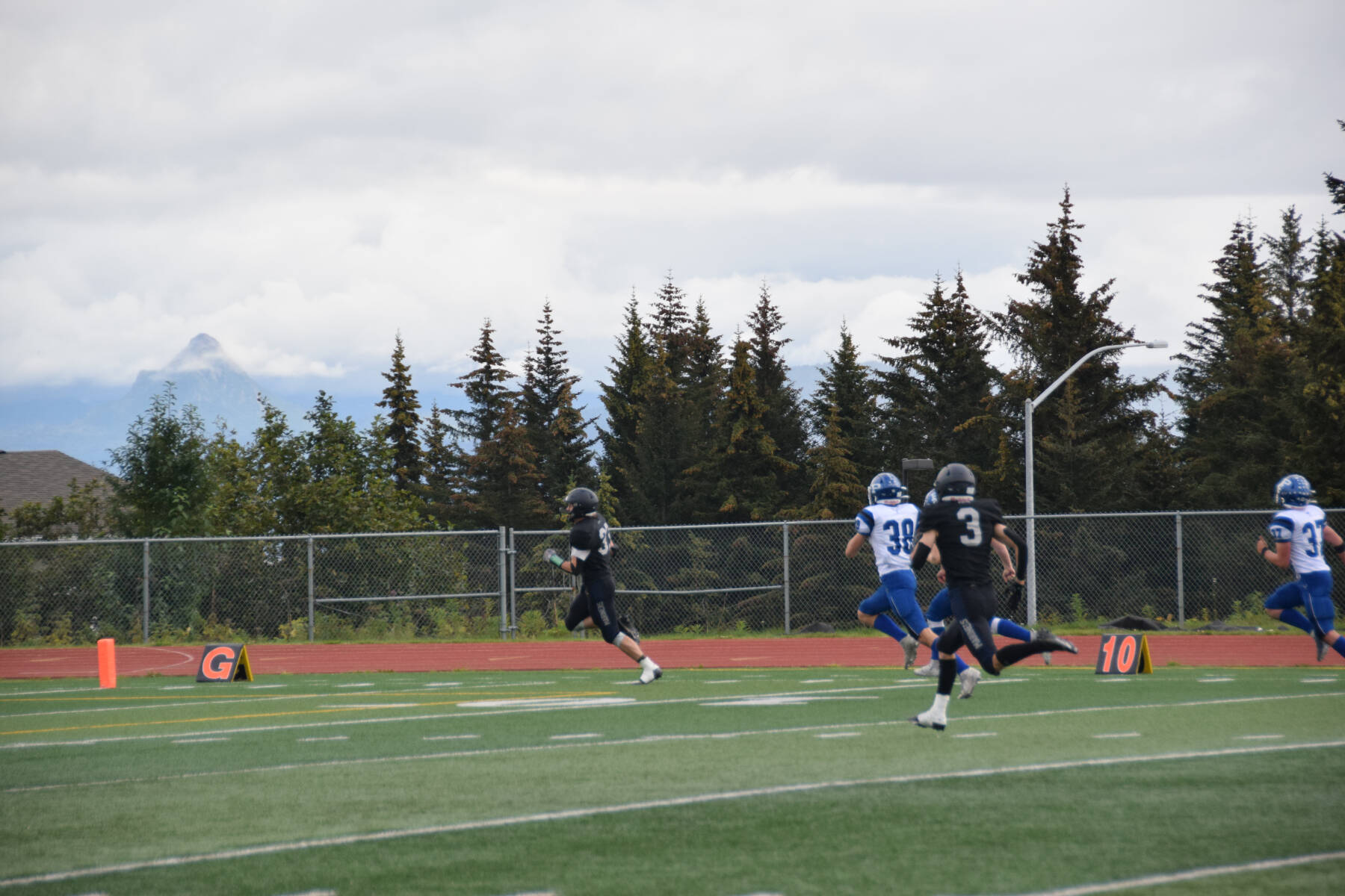 Jake Tappan runs to score the first touchdown for Homer at the homecoming game against Palmer on Friday, Sept. 8, 2023 in Homer, Alaska. (Delcenia Cosman/Homer News)