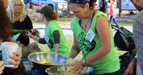 Volunteers work the fermentation station at the Harvest Moon Local Food Festival at Soldotna Creek Park on Sept. 14, 2019. (Photo by Brian Mazurek/Peninsula Clarion)
