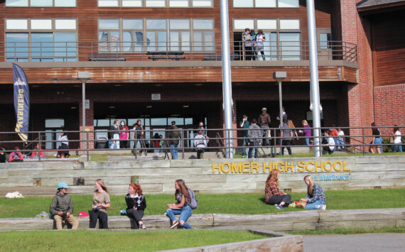 Homer High School students finish eating lunch outside the school while others make their way back into the building for the next class period on Monday, Aug. 24, 2020, in Homer, Alaska. (Photo by Megan Pacer/Homer News file)