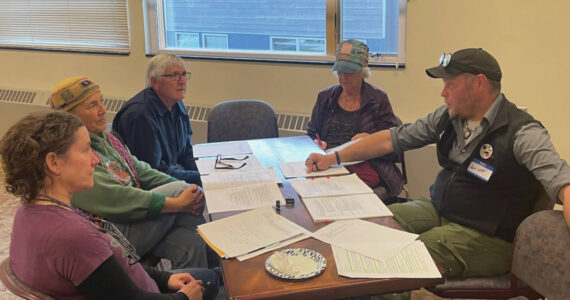 Homer community members talk with Matt Steffy, parks and trails planner with the City of Homer, about the trails and sidewalk component of the draft transportation plan on Sept. 26.  Emilie Springer/ Homer News