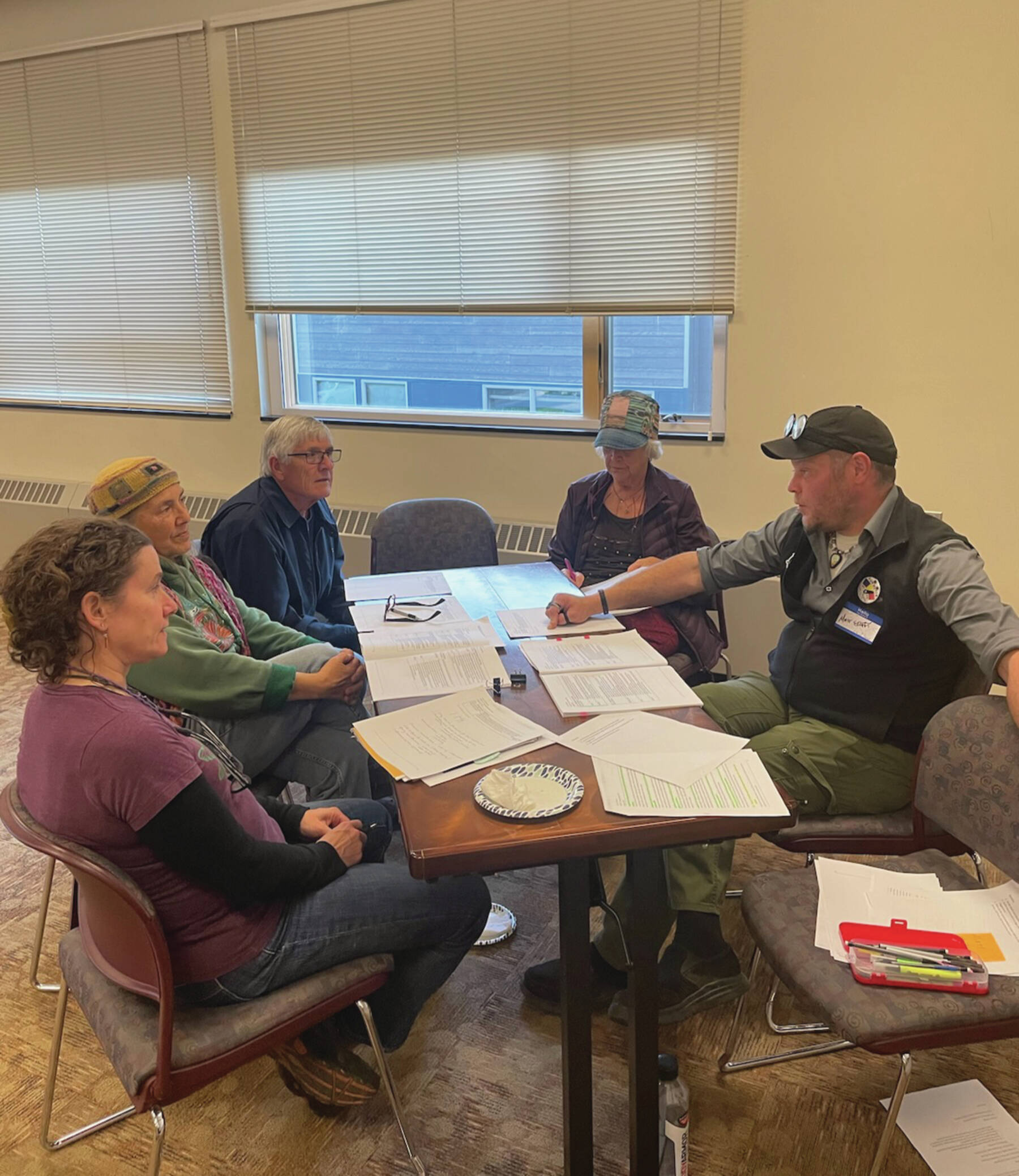 Homer community members talk with Matt Steffy, parks and trails planner with the City of Homer, about the trails and sidewalk component of the draft transportation plan on Sept. 26.  Emilie Springer/ Homer News