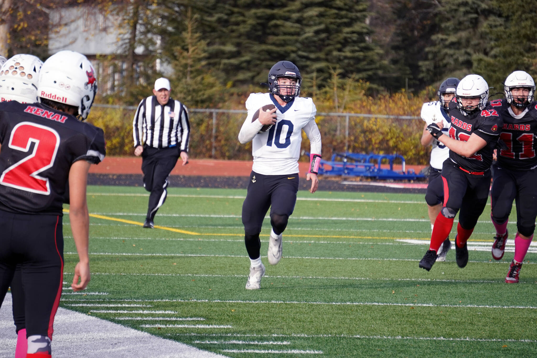 Homer’s Preston Stanislaw runs with the ball pursued by Kenai’s Elliot Haakenson during a Division III playoff game at Justin Maile Field in Soldotna, Alaska, on Saturday, Oct. 7, 2023. (Jake Dye/Peninsula Clarion)