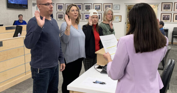 From left, Kenai Peninsula Borough School District Board of Education members Jason Tauriainen, Kelley Cizek, Dianne MacRae and Penny Vadla are sworn in by District Secretary Nikkol Sipes during a special school board meeting on Monday, Oct. 16, 2023 in Soldotna, Alaska. (Ashlyn O’Hara/Peninsula Clarion)