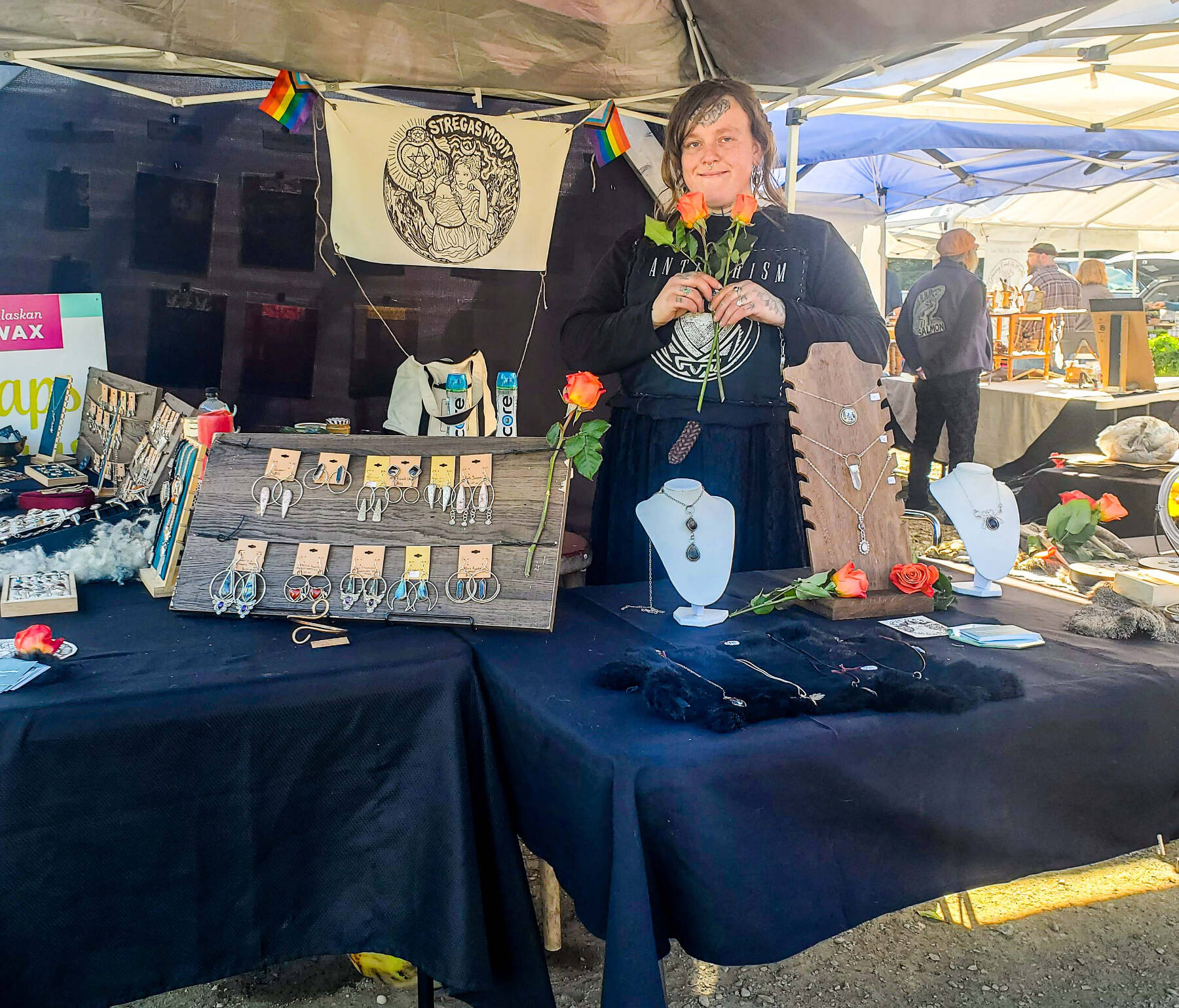 Artist Carley Conemac is photographed at her Homer Farmers Market booth in July 2023. Photo by Syd Paulino