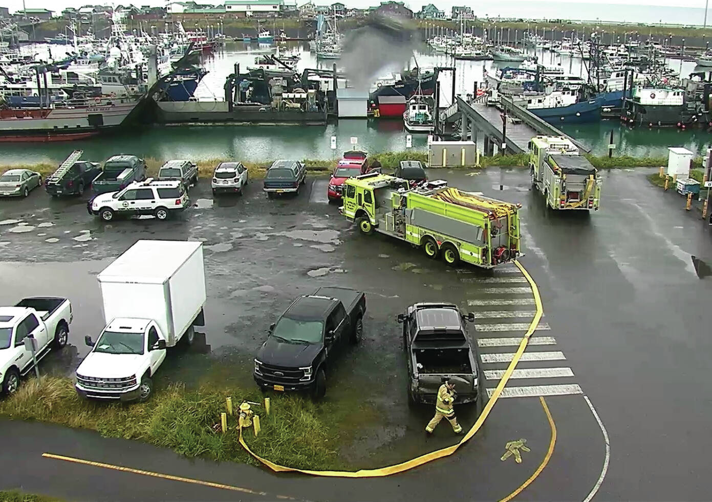 Photo provided by a Homer Harbor surveillance camera
Fire crew respond to a vessel fire on Oct. 13 in the Homer Harbor.
