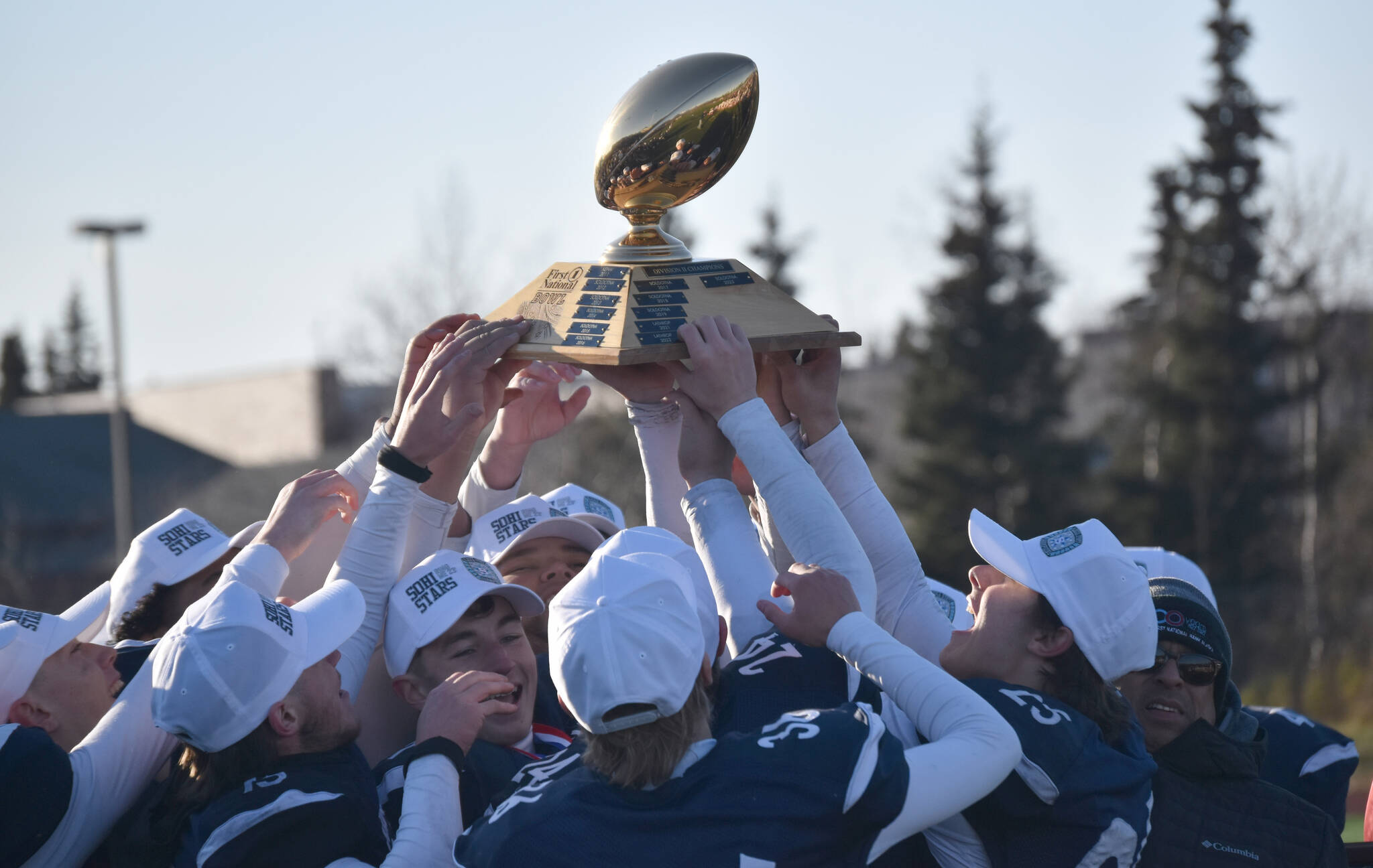 Soldotna hoists the First National Bowl on Saturday, Oct. 21, 2023, after the Division II championship game at Service High School in Anchorage, Alaska. (Photo by Jeff Helminiak/Peninsula Clarion)