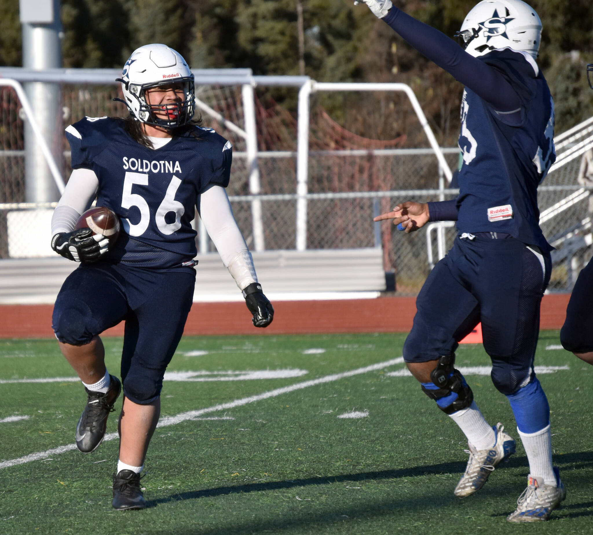 Soldotna’s Koda Lepule celebrates a fumble recovery with Elijah Lee on Saturday, Oct. 21, 2023, in the Division II championship game at Service High School in Anchorage, Alaska. (Photo by Jeff Helminiak/Peninsula Clarion)