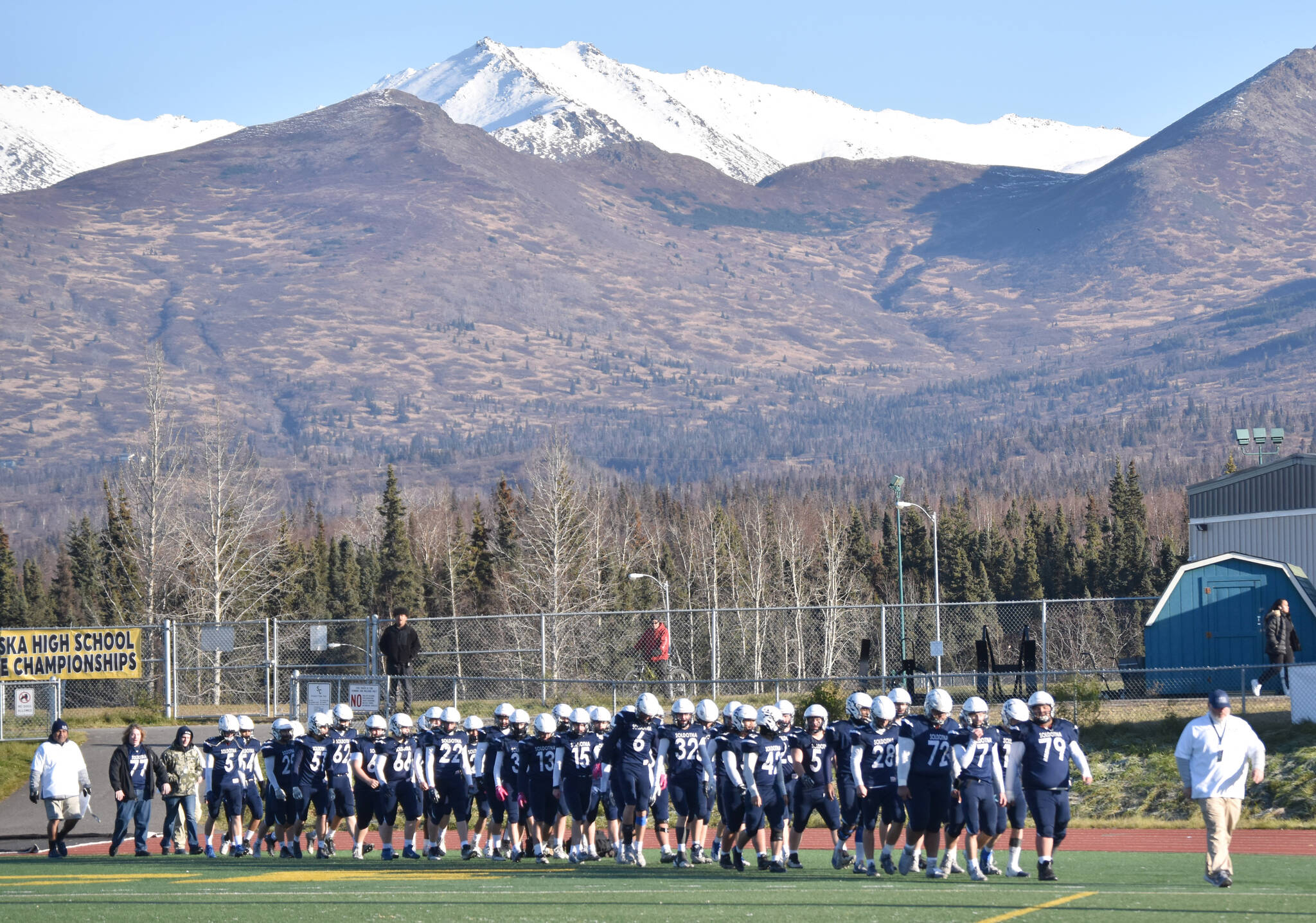 Soldotna head coach Galen Brantley Jr. leads his team back on the field after halftime Saturday, Oct. 21, 2023, in the Division II championship game at Service High School in Anchorage, Alaska. (Photo by Jeff Helminiak/Peninsula Clarion)