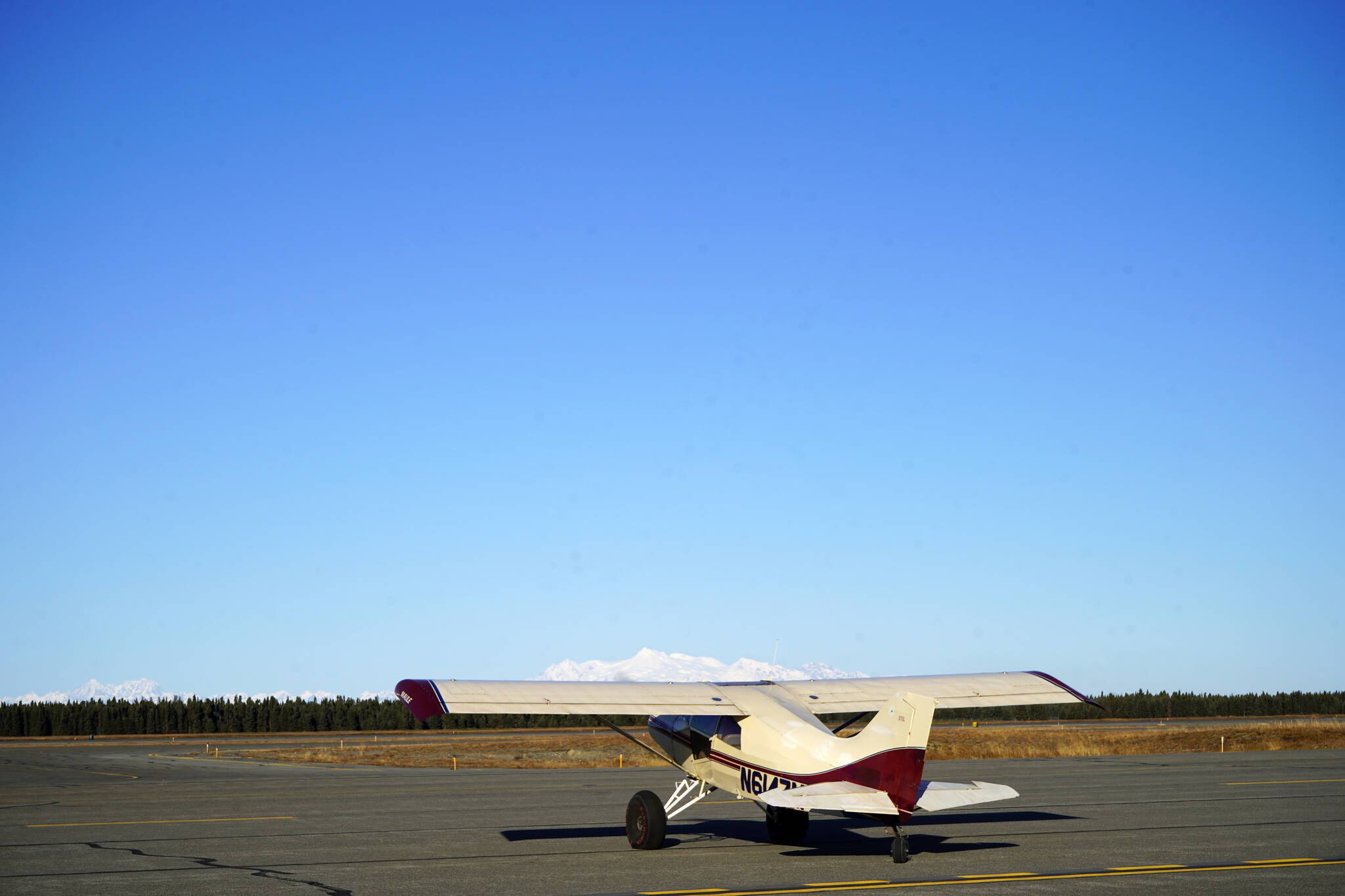 A plane idles on the runway, waiting to depart with a pumpkin, during Kenai Aviation’s Fifth Annual Pumpkin Drop at the Kenai Municipal Airport Operations Building in Kenai, Alaska, on Saturday, Oct. 21, 2023. (Jake Dye/Peninsula Clarion)
