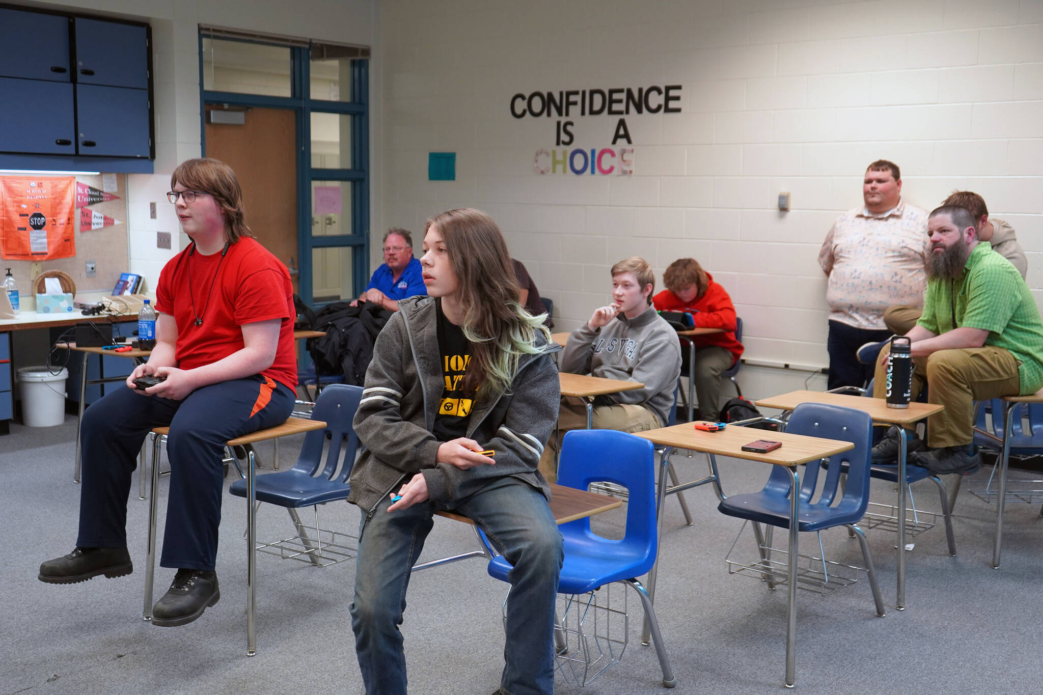 Players, coaches and parents watch as Kenai’s Boyd Lehmberg and Nikiski’s Lincoln Kimbell play the final round of competition for a Super Smash Bros. Ultimate match at Nikiski Middle/High School in Nikiski, Alaska, on Monday, Oct. 23, 2023. (Jake Dye/Peninsula Clarion)
